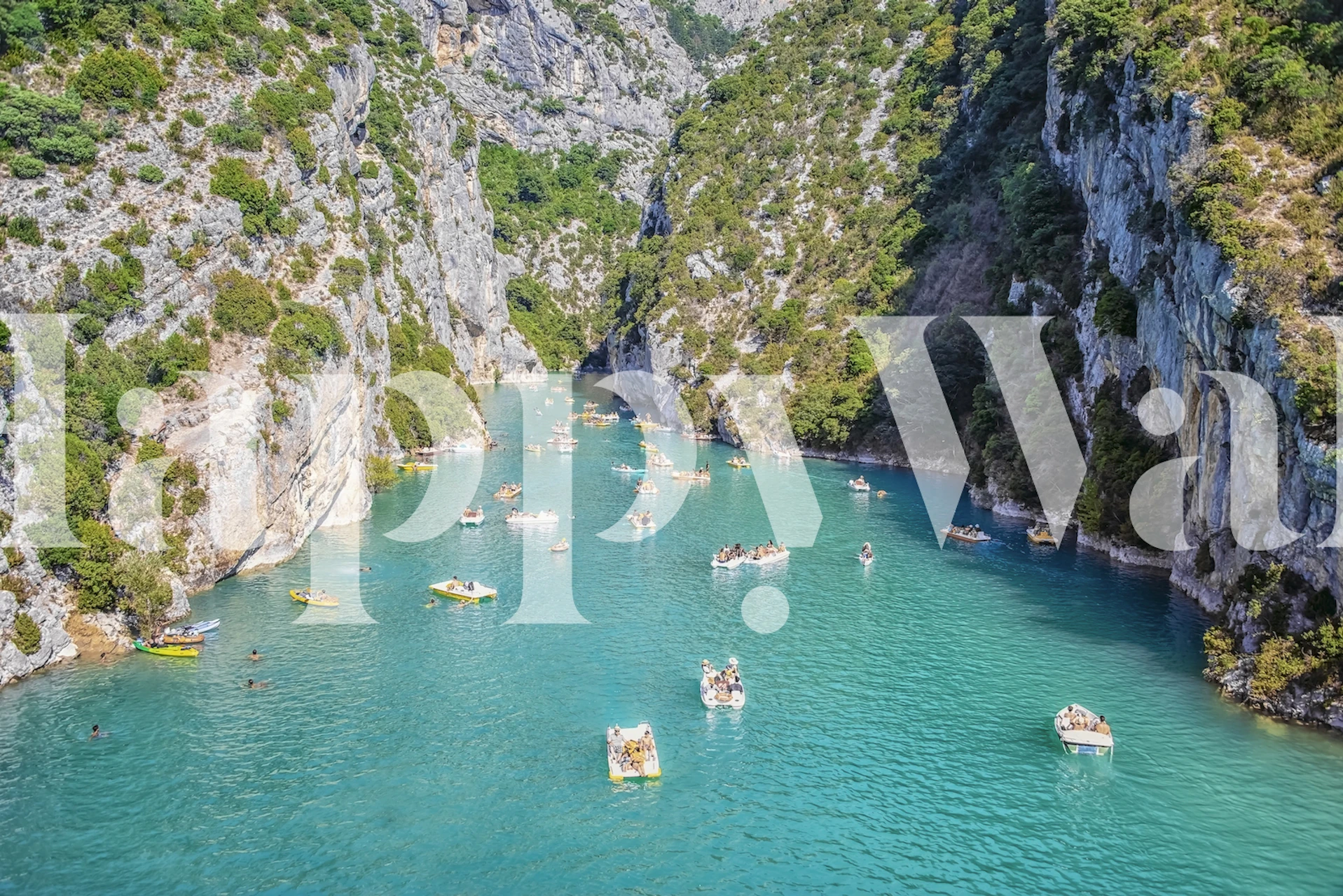 Turquoise lake with boats and rocky green cliffs wallpaper