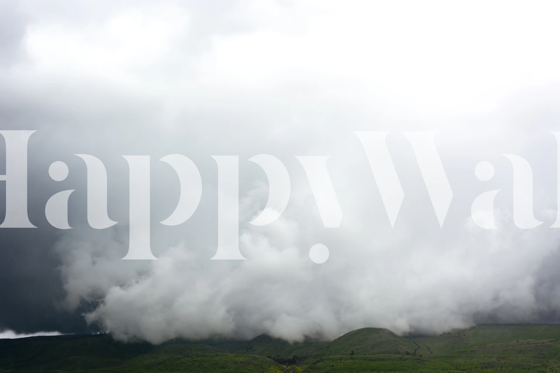 Misty gray mountains under a cloudy sky wallpaper