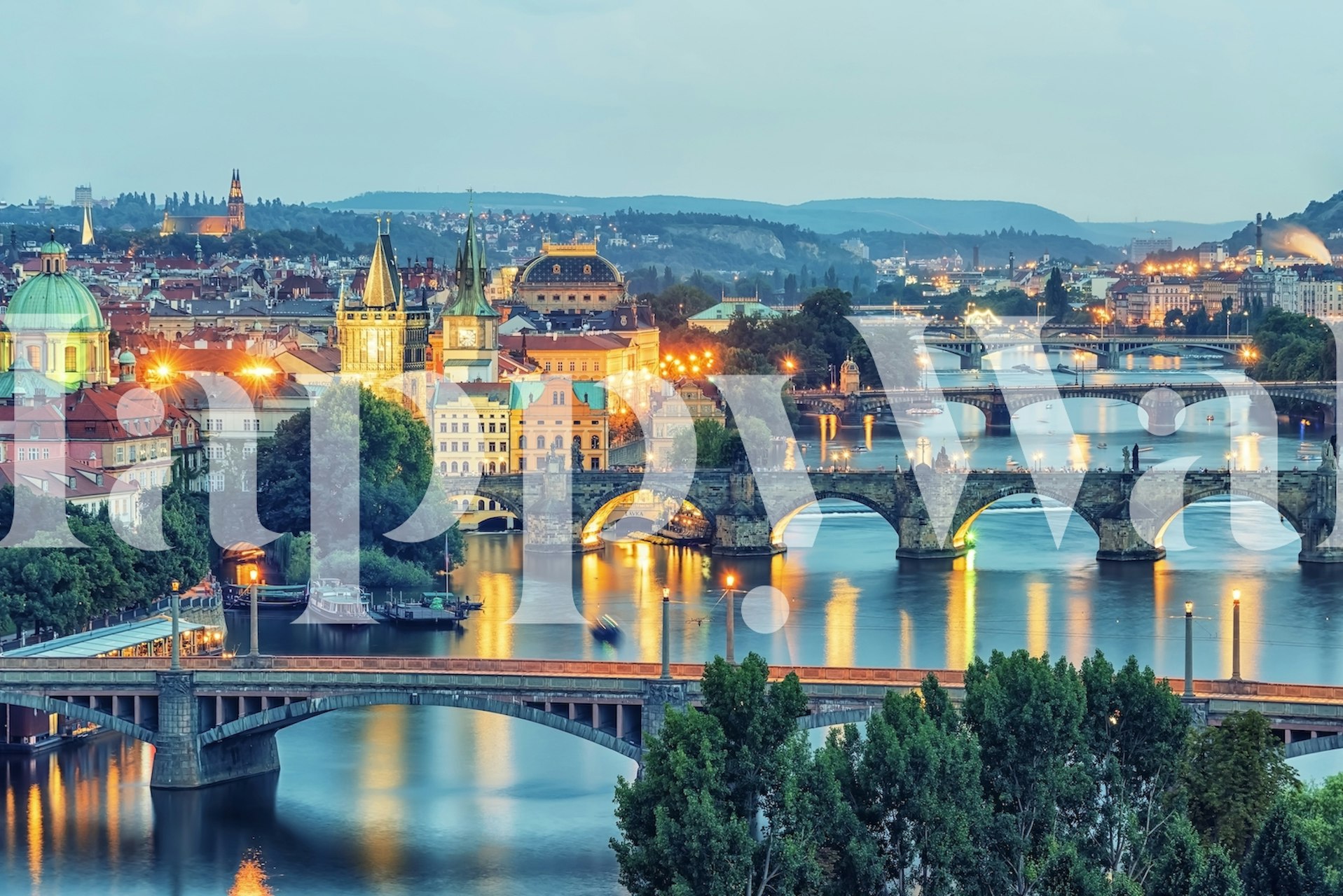Prague cityscape at dusk with blue hues and illuminated buildings wallpaper
