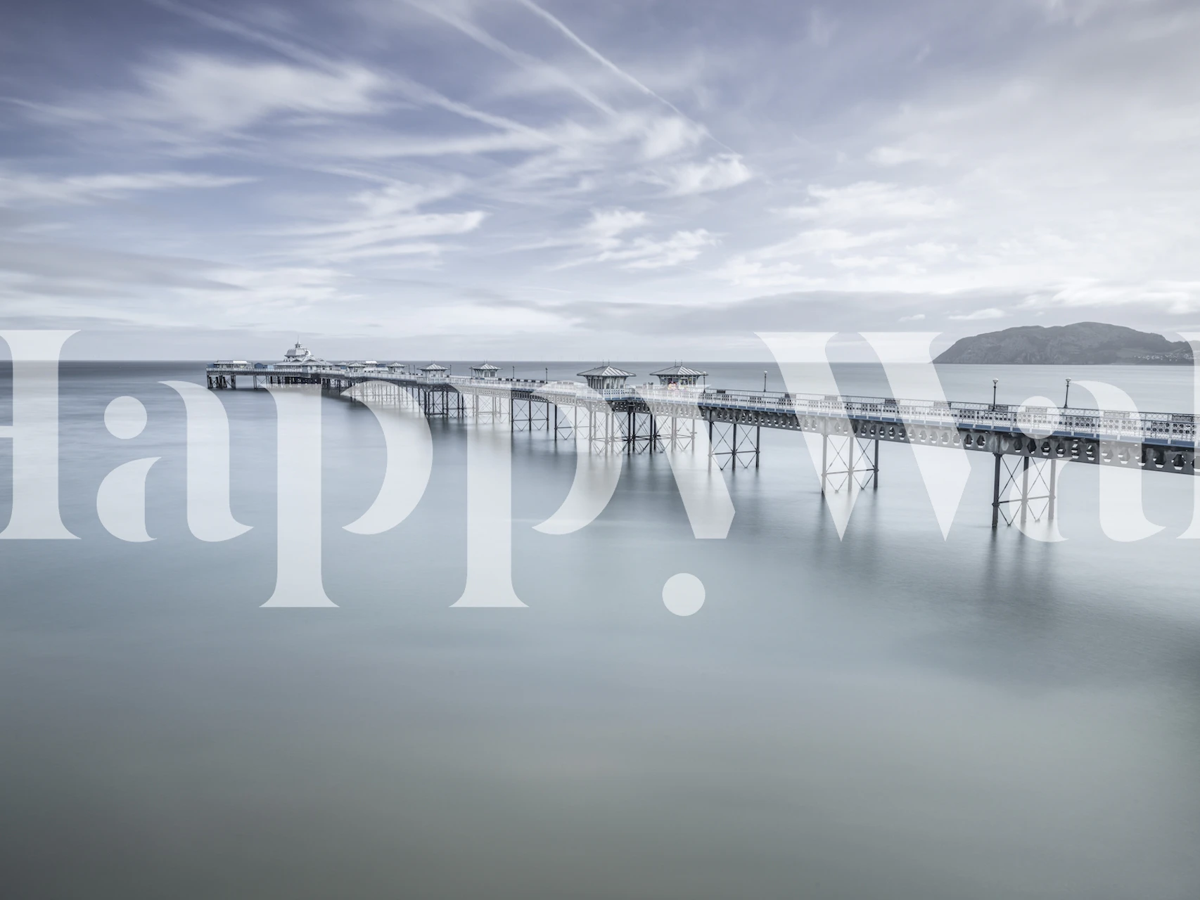 Serene seascape wall mural featuring the historic Llandudno Pier in soft light