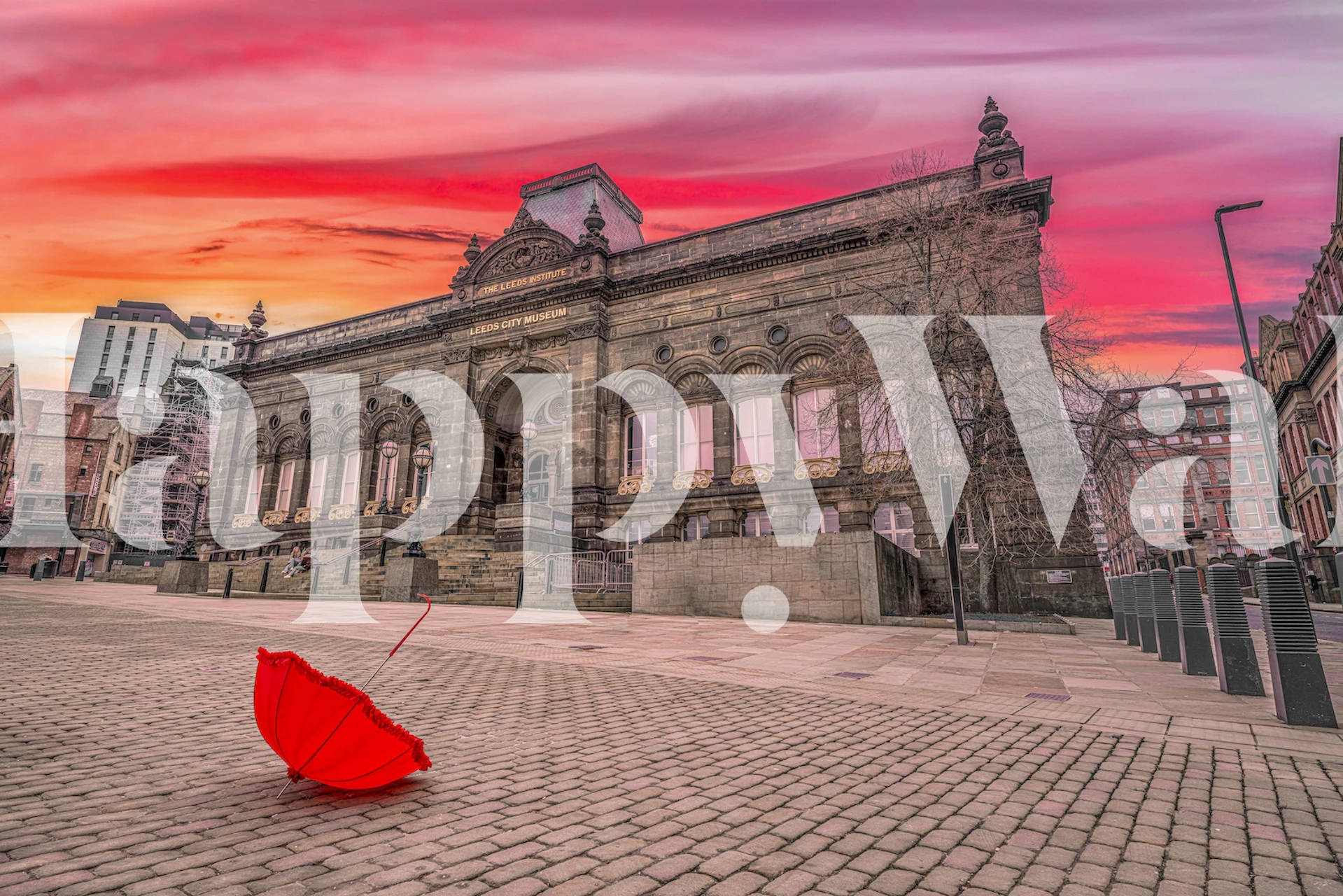 Red umbrella on cobblestone street with historic building and colorful sky wallpaper