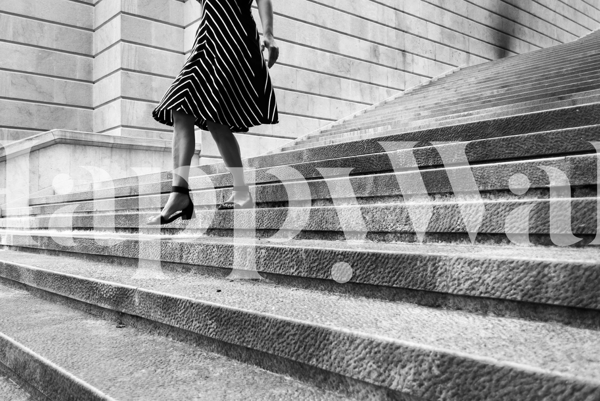 Monochrome image of a person walking up stairs in striped clothing for Escape Myself mural