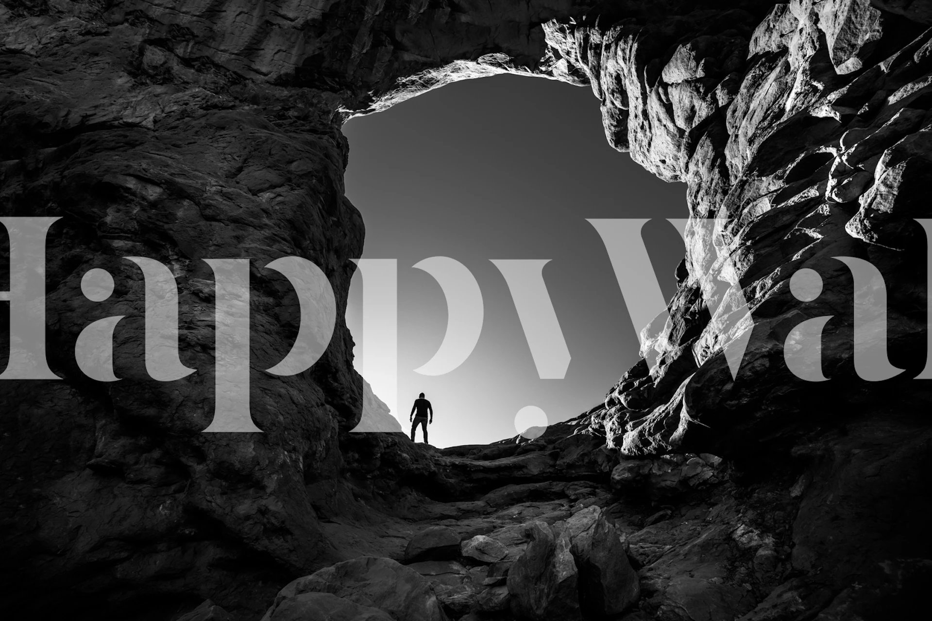 Cave landscape with silhouetted figure, black and white wallpaper