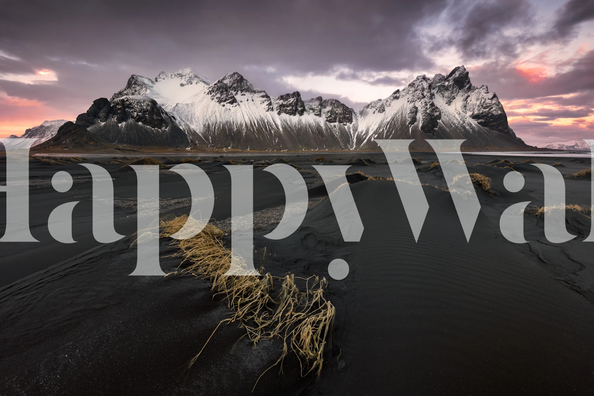 Black sands patterned wallpaper with mountains and golden grass