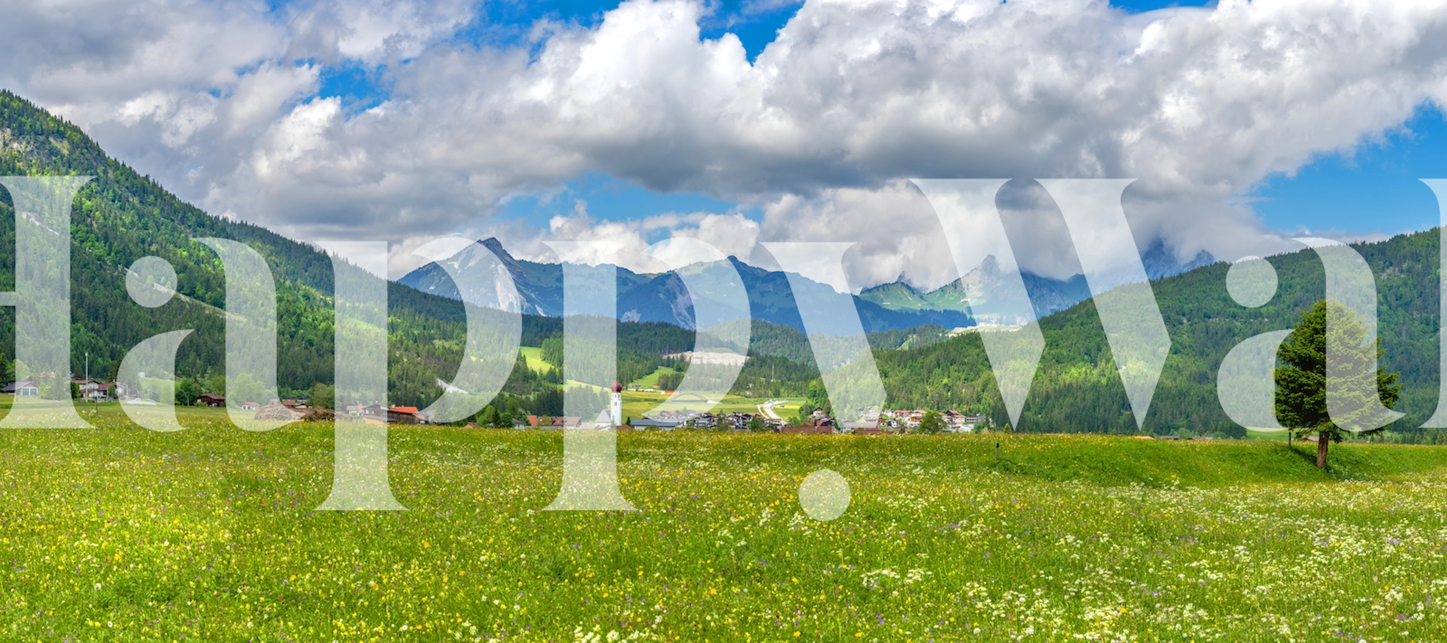 Lush green landscape with mountains and clouds wallpaper