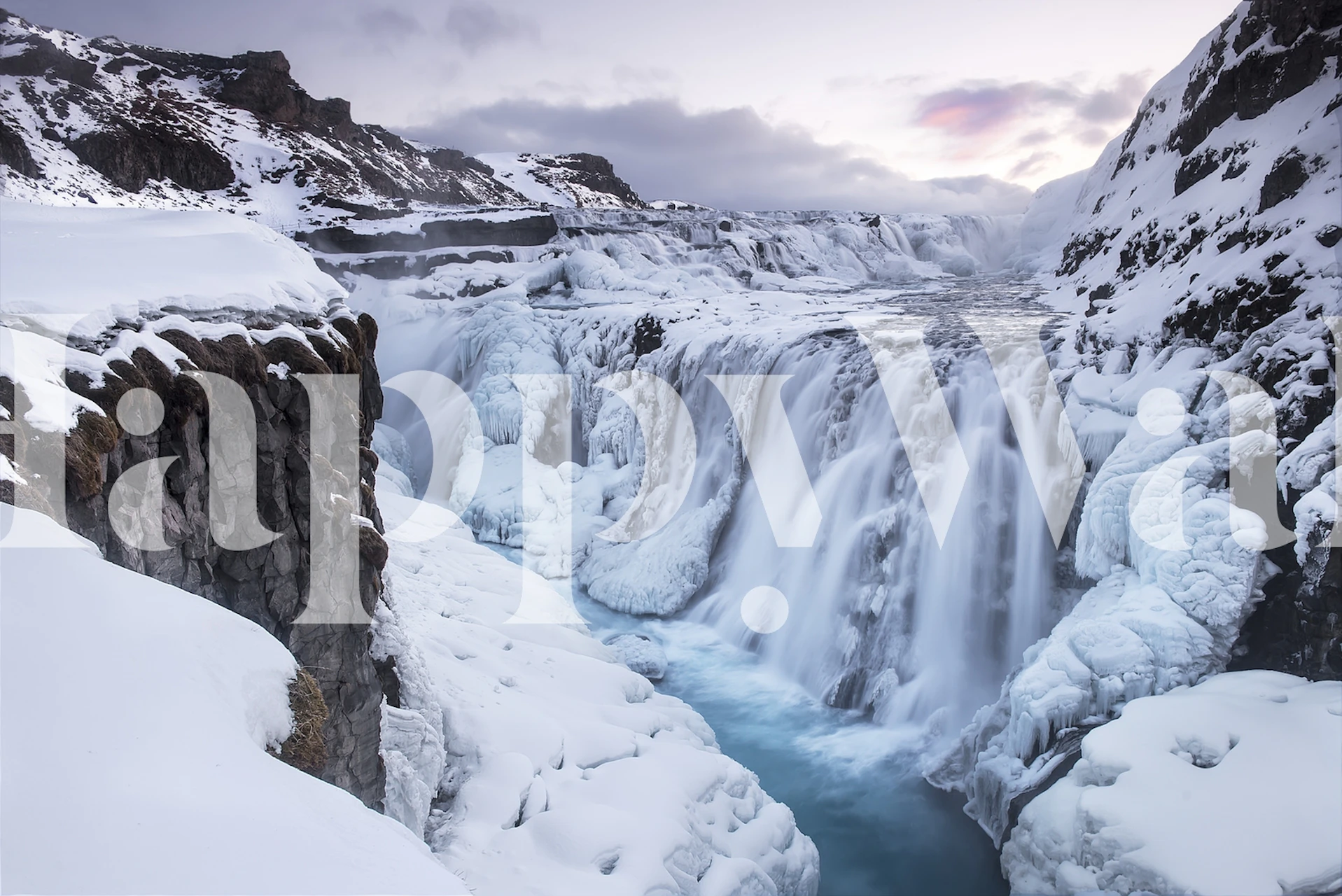 Frozen waterfall with icy blue and white tones wallpaper