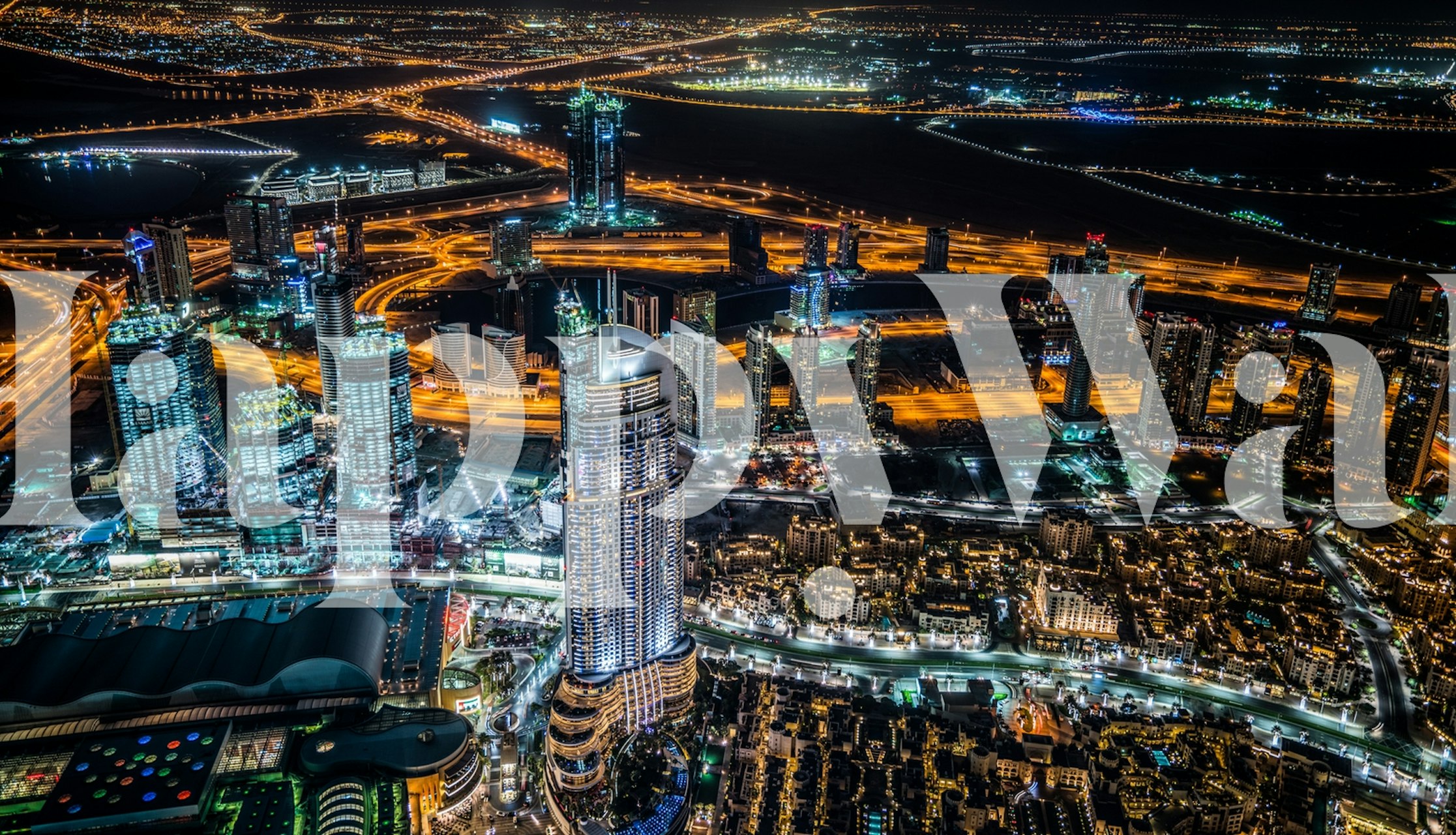 Dubai night city skyline with bright lights wallpaper