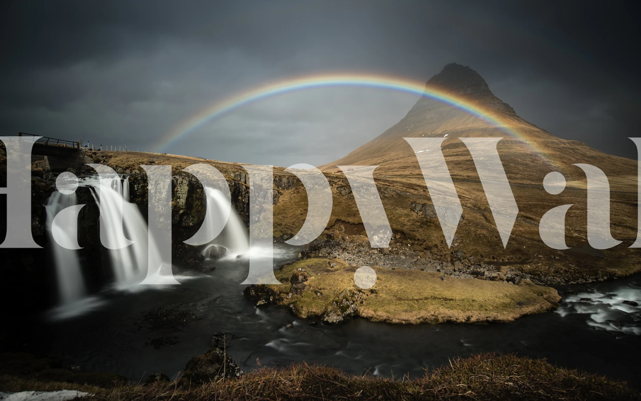 Kirkjufell mountain in Iceland with waterfall and rainbow wall mural