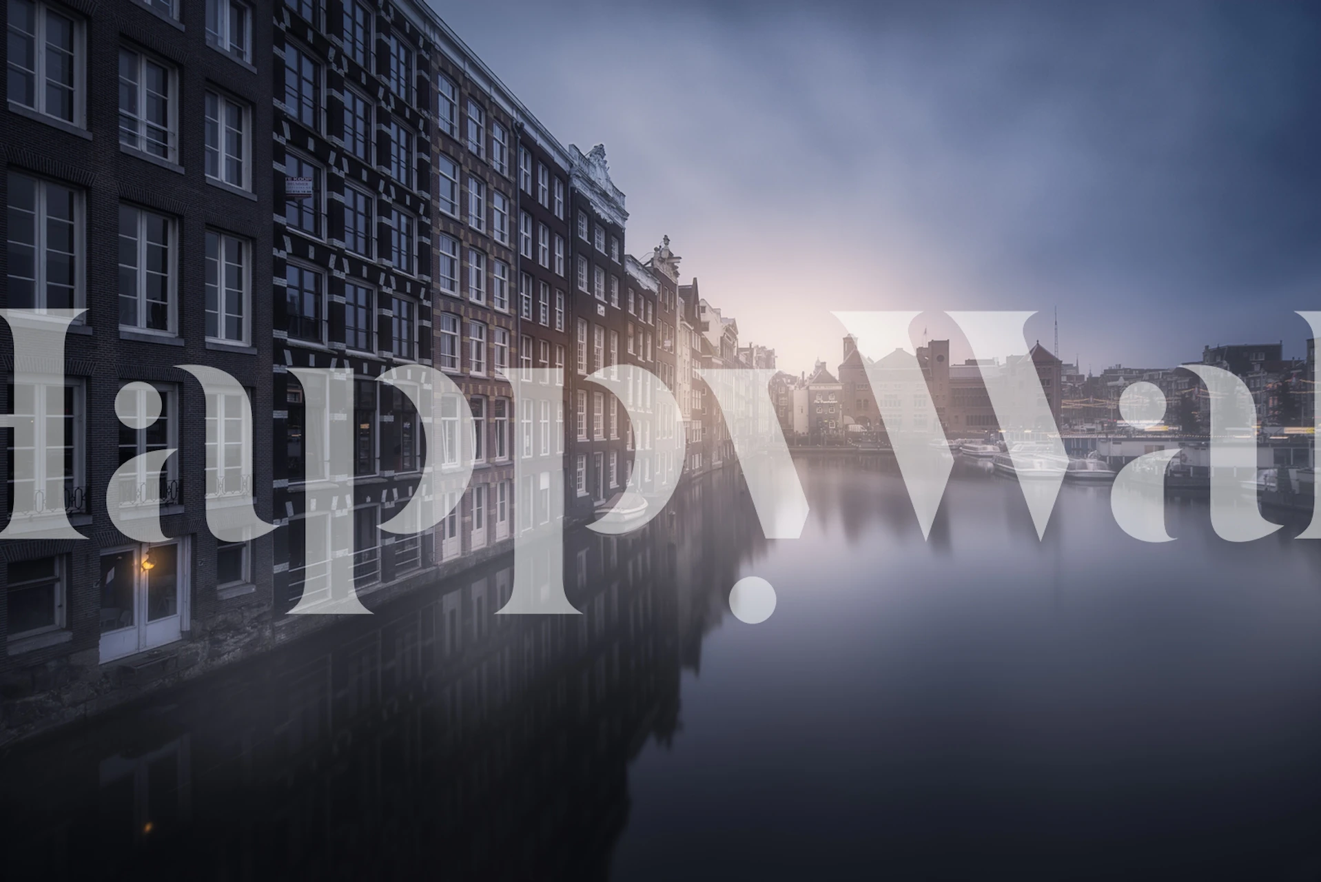 Amsterdam canal in the morning light with historic buildings reflected on water