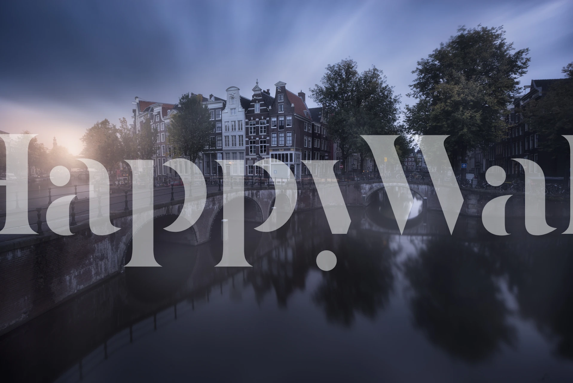 Amsterdam canal scene with buildings and trees wallpaper