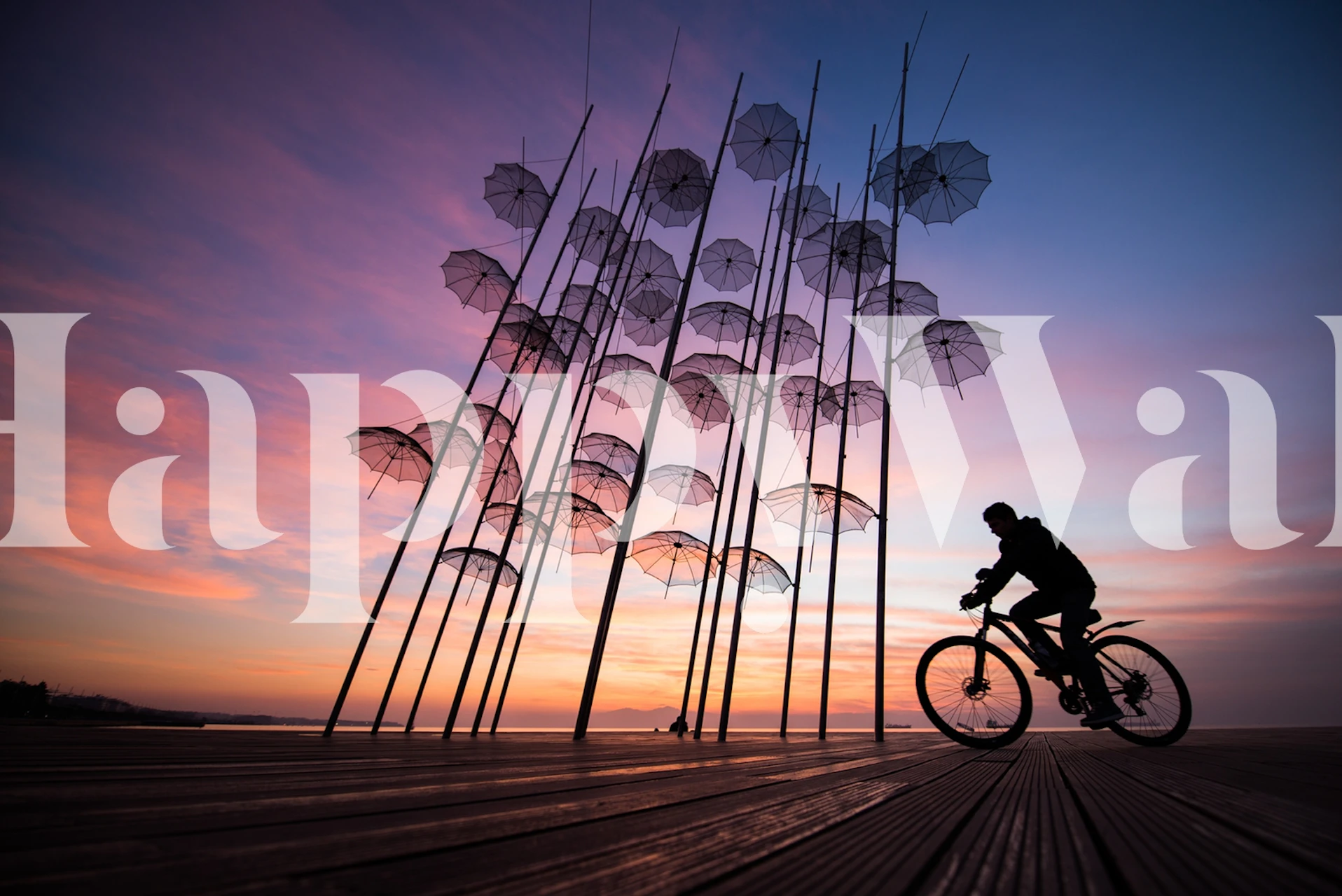 Colorful umbrellas against a sunset sky wallpaper