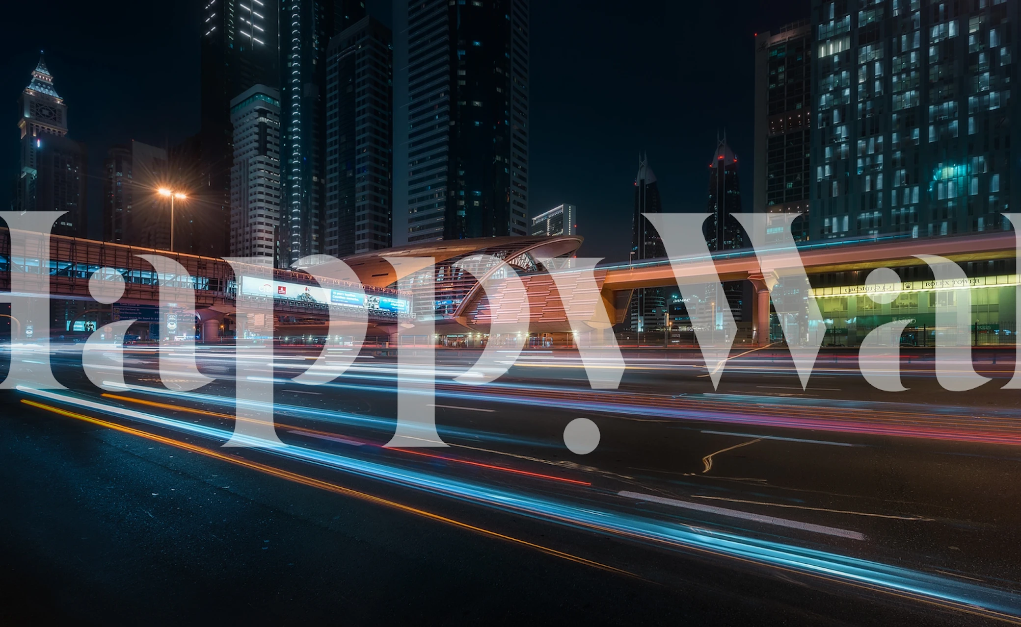 Cityscape at night with light trails from moving vehicles on The Station wall mural.