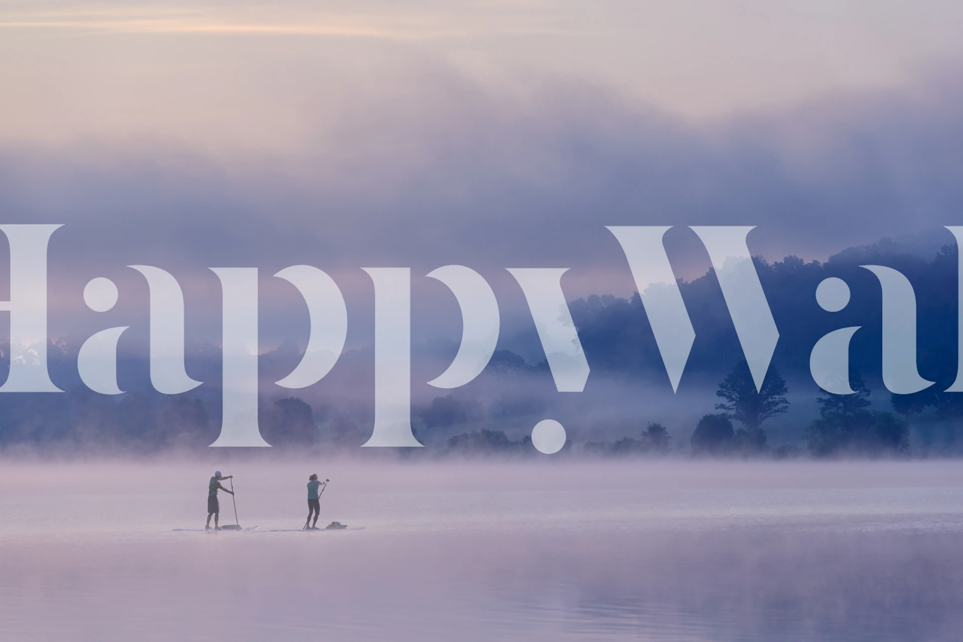 Misty lake wallpaper with paddleboarders