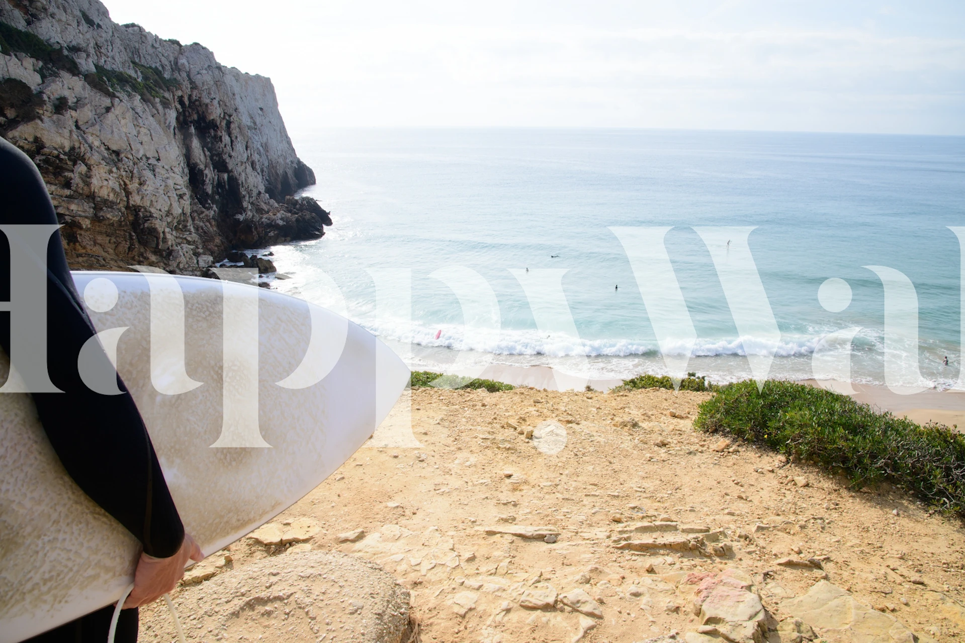 Surfing beach scene wallpaper featuring ocean waves and cliffs