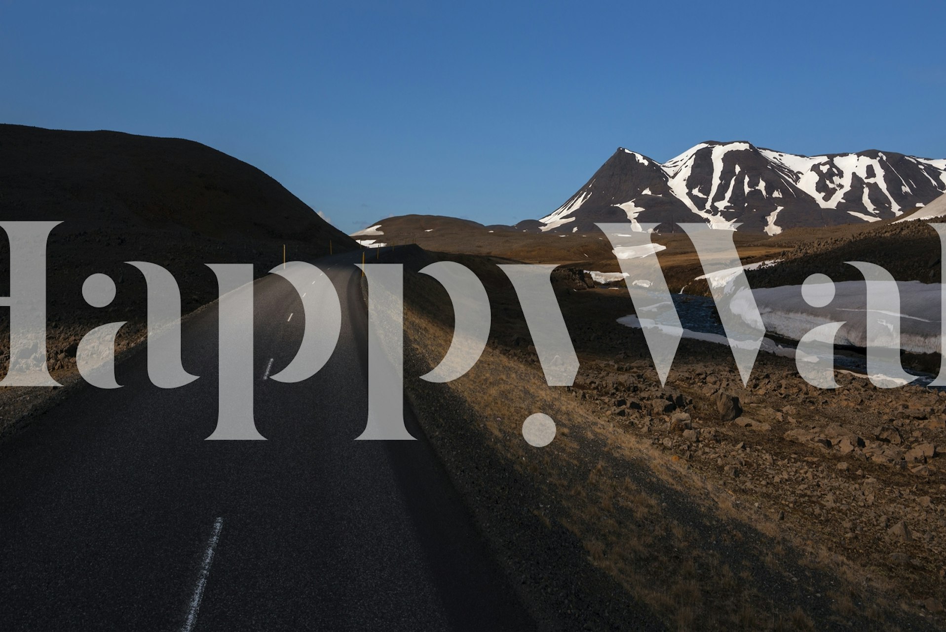 Open highway with mountains in the background wall mural