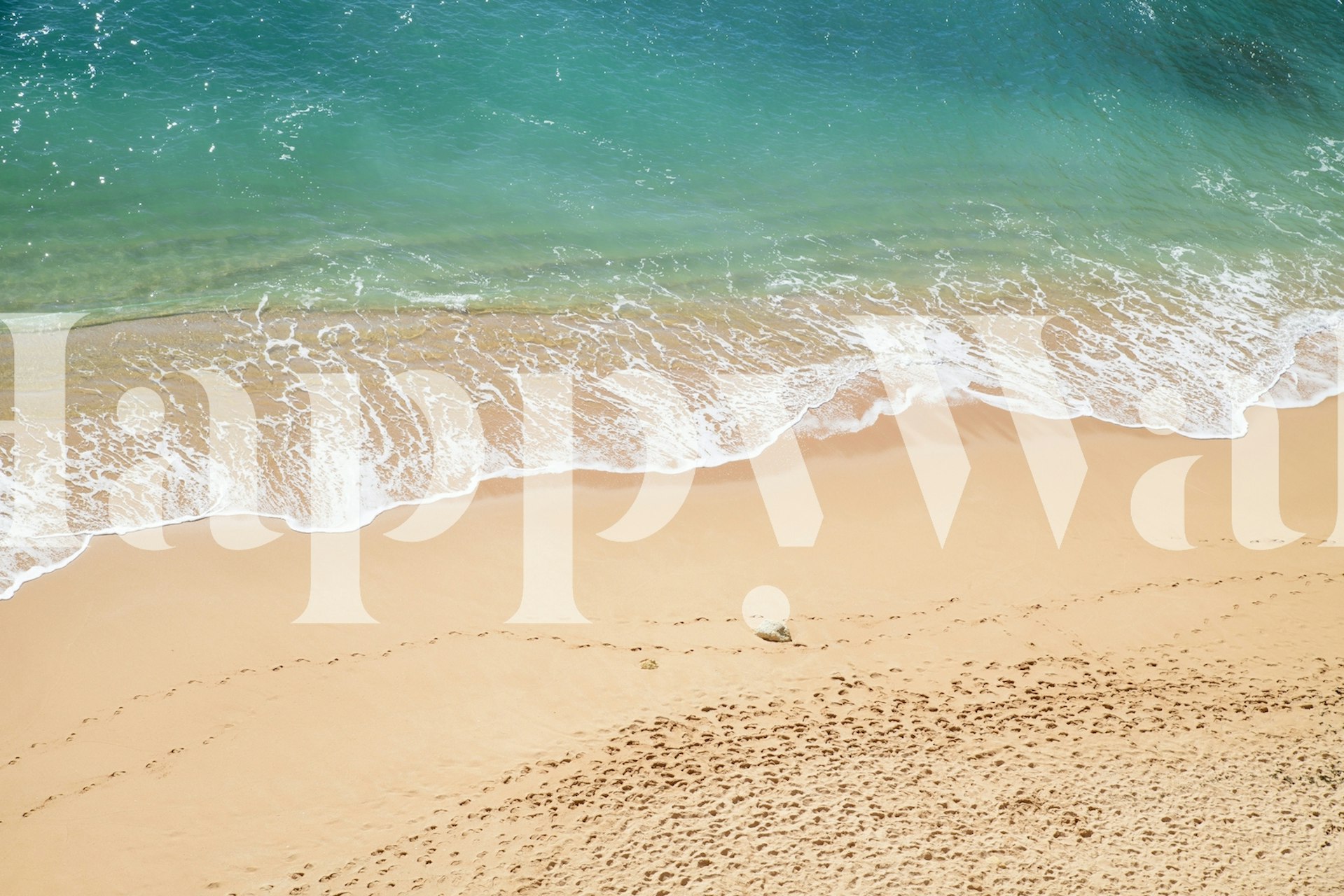 Ocean waves on a sandy beach with blue water, photographic wallpaper