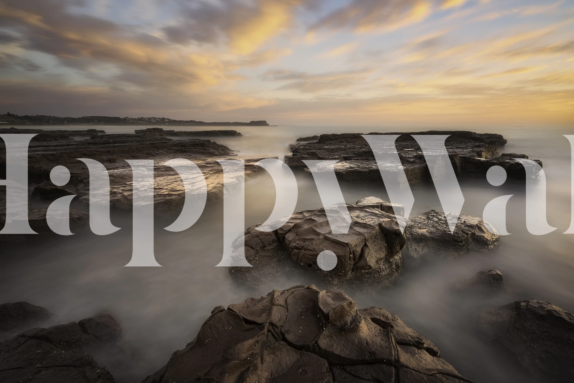 Coastal rocks with calm water and soft sunset colors wallpaper