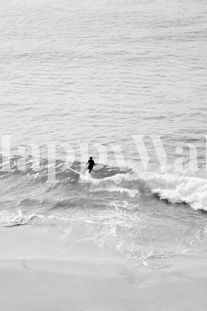 A surfer riding a wave in black and white photography wallpaper