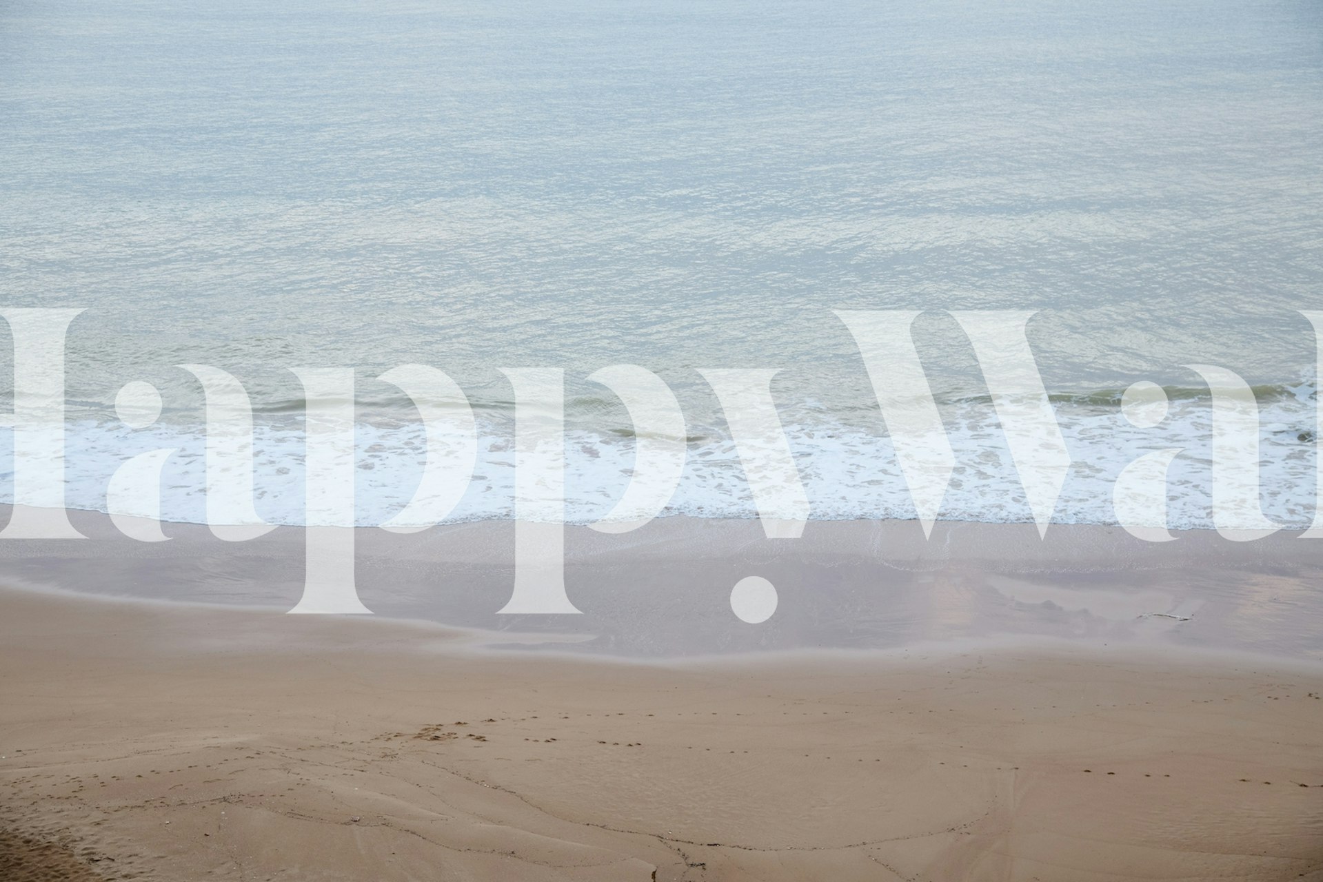 Beach sunrise wall mural with gentle waves and sandy shore