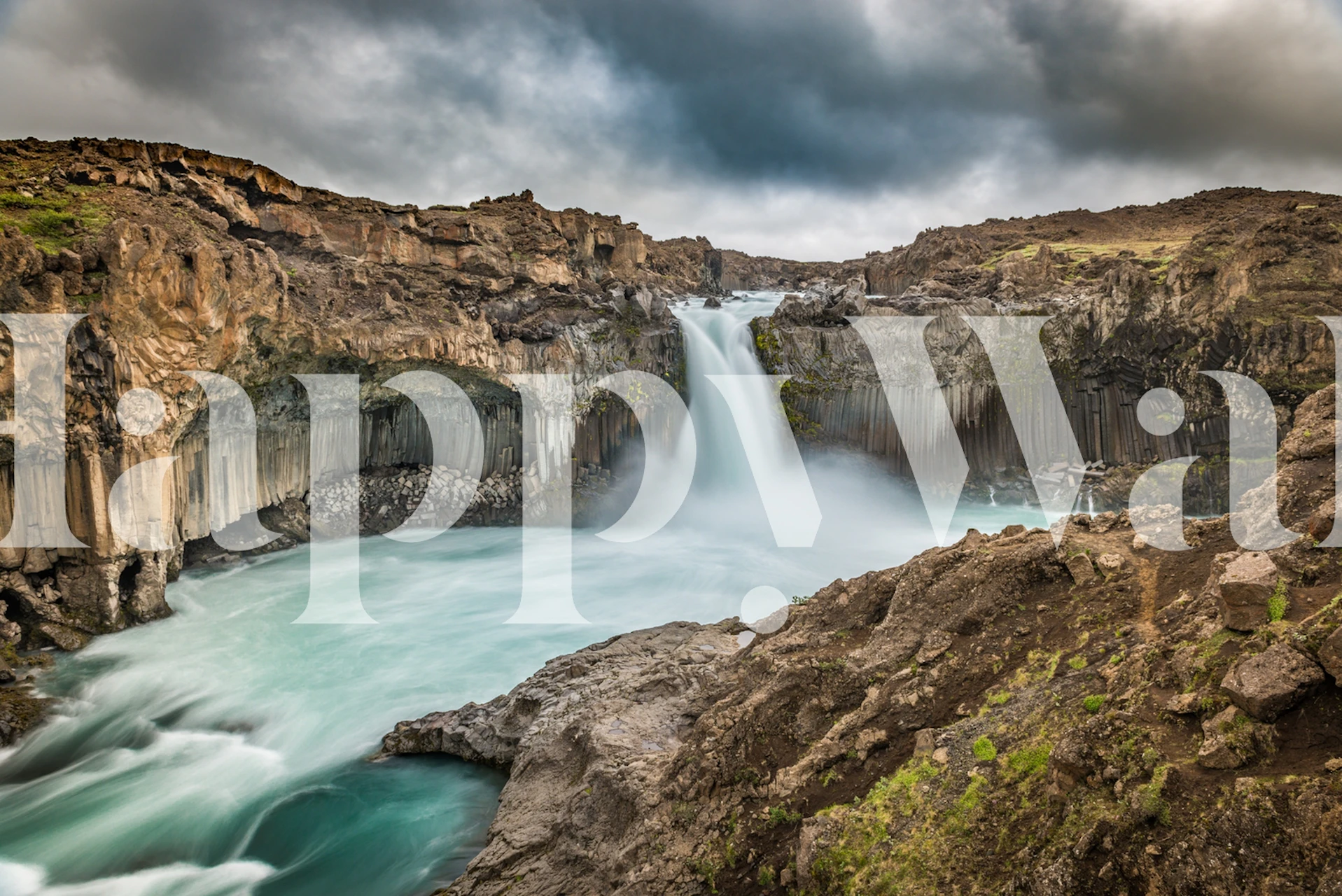 Majestic waterfall with rocky cliffs and vibrant water tones wallpaper