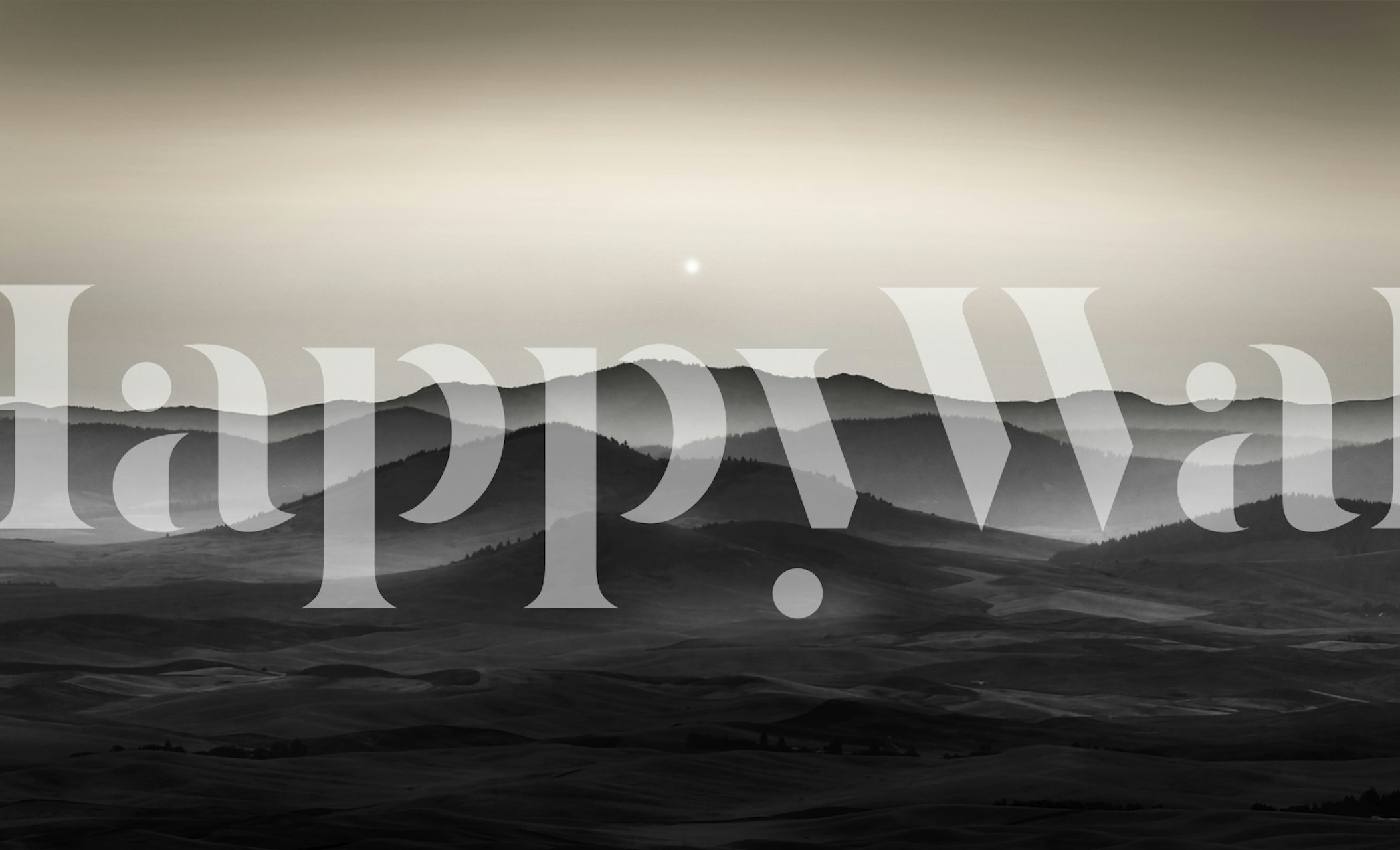 Black and white landscape wallpaper with rolling hills and misty mountains