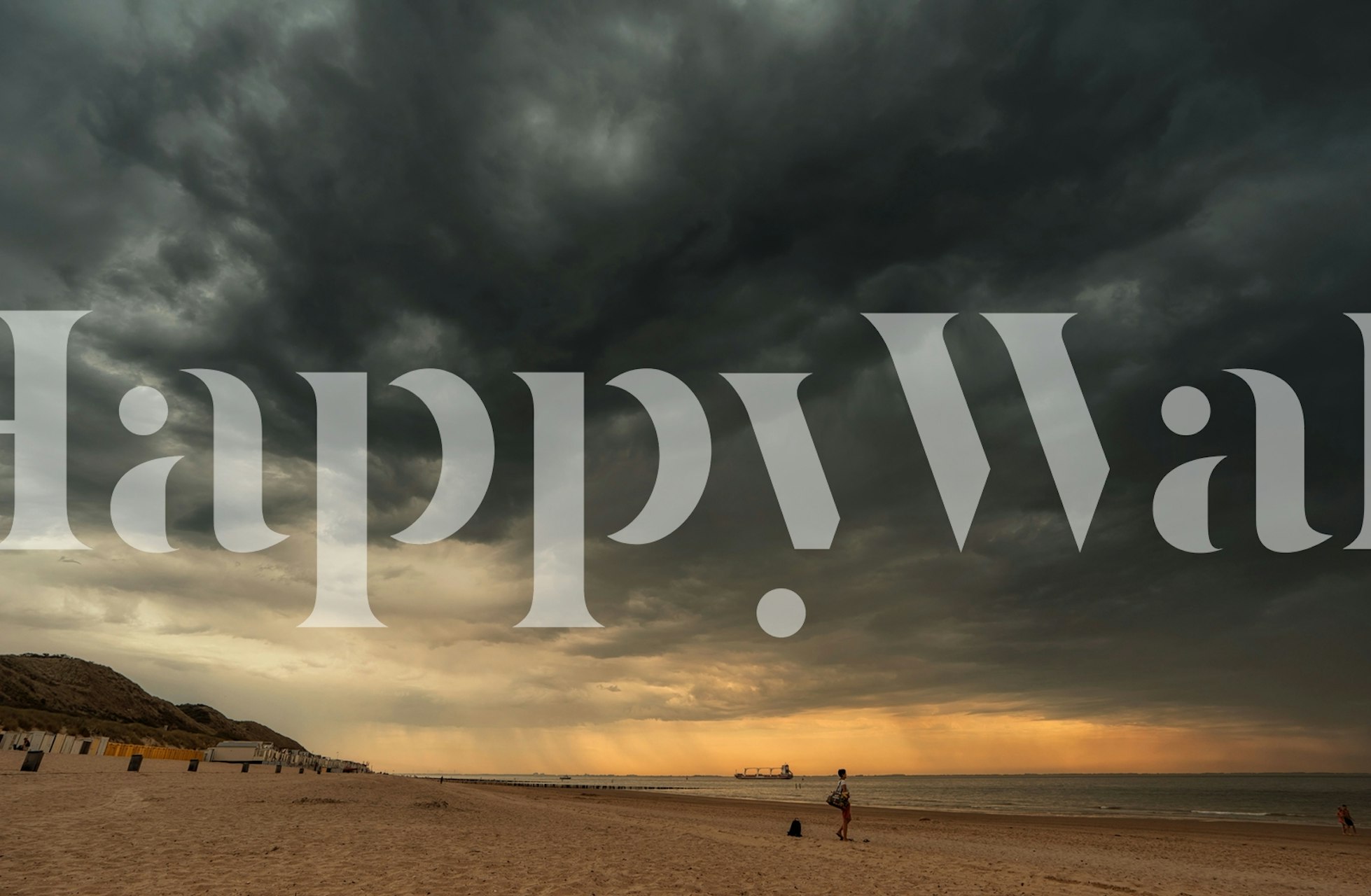 Stormy coastal sunset scene with dark clouds and sandy beach wallpaper