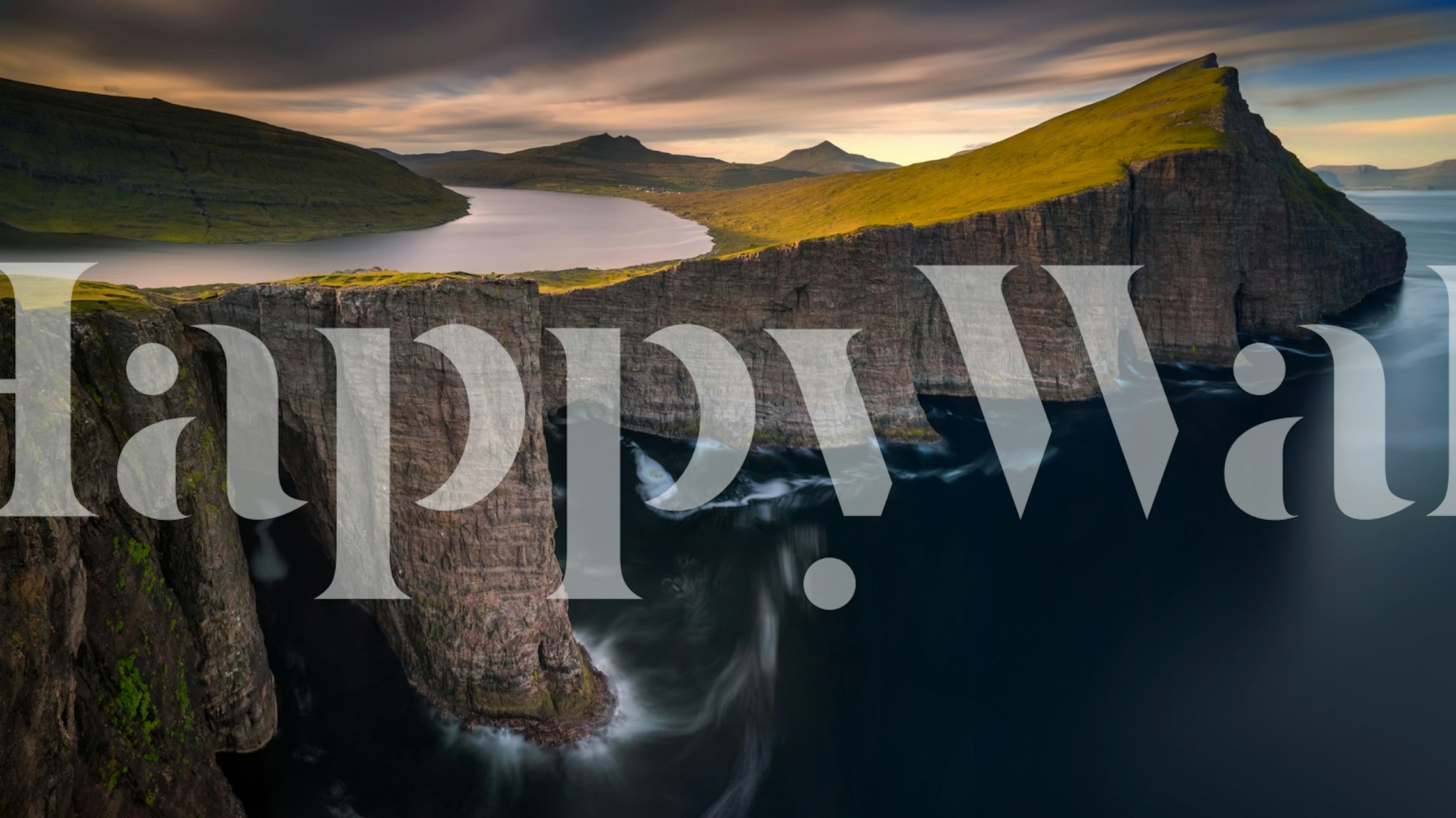 Dramatic cliffs with tranquil water and hills wallpaper