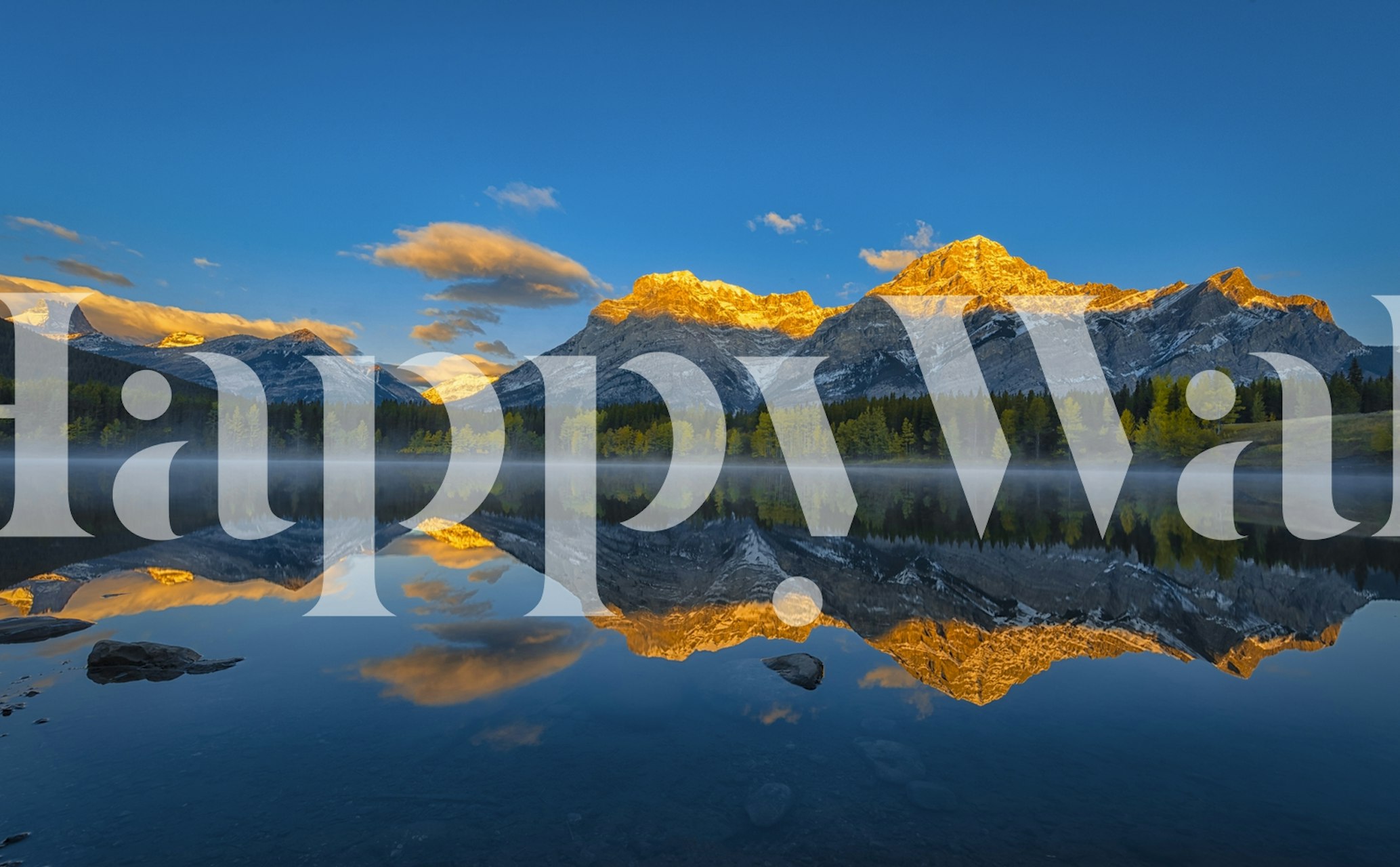 Mountain peaks reflecting in a serene lake with a vibrant sunset sky wallpaper