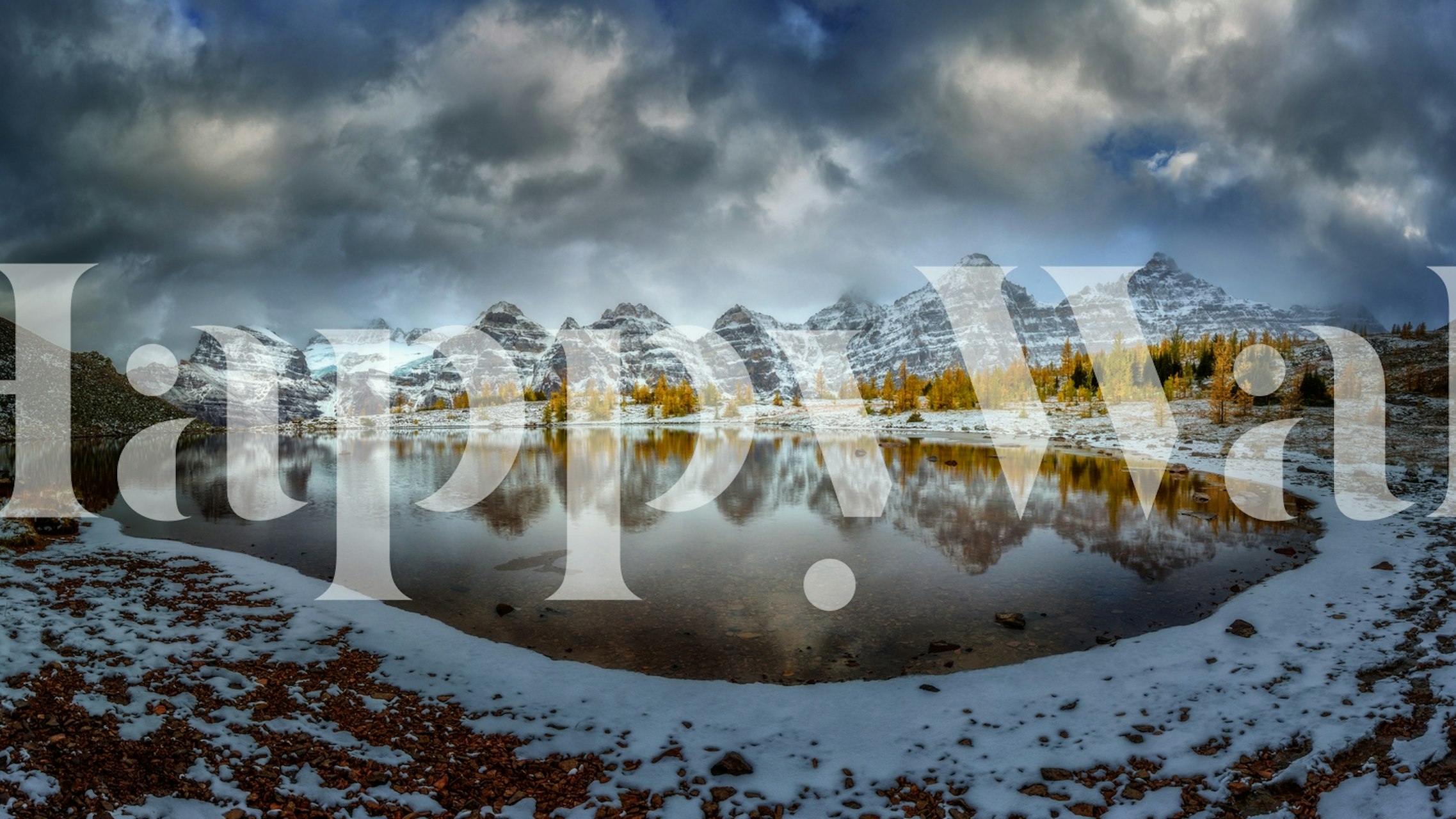 Snowy mountains reflected in a tranquil lake at dusk wallpaper