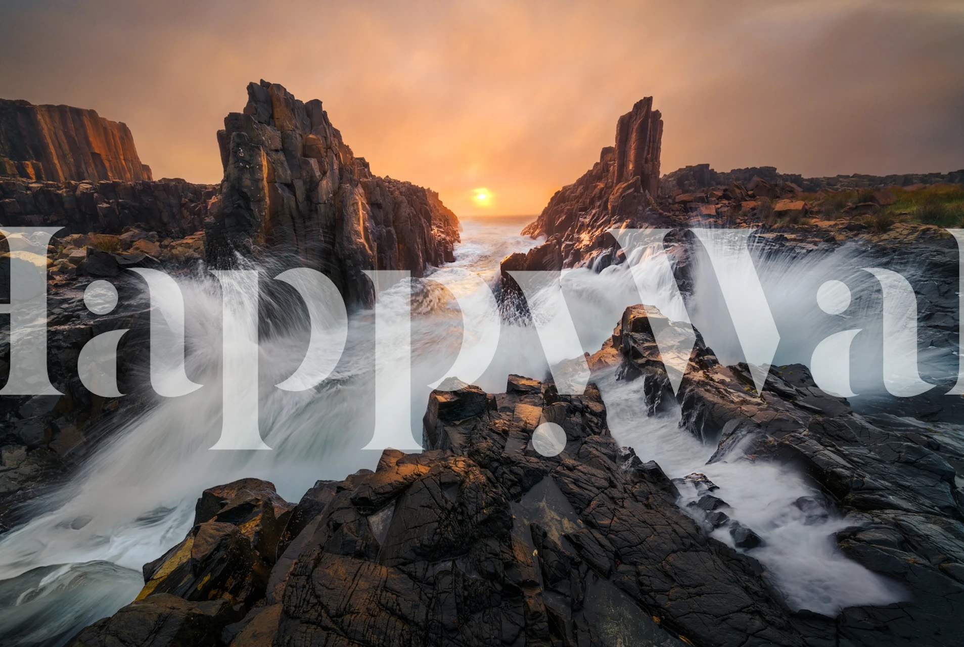 Coastal sunset with dynamic waves and rocky cliffs wallpaper