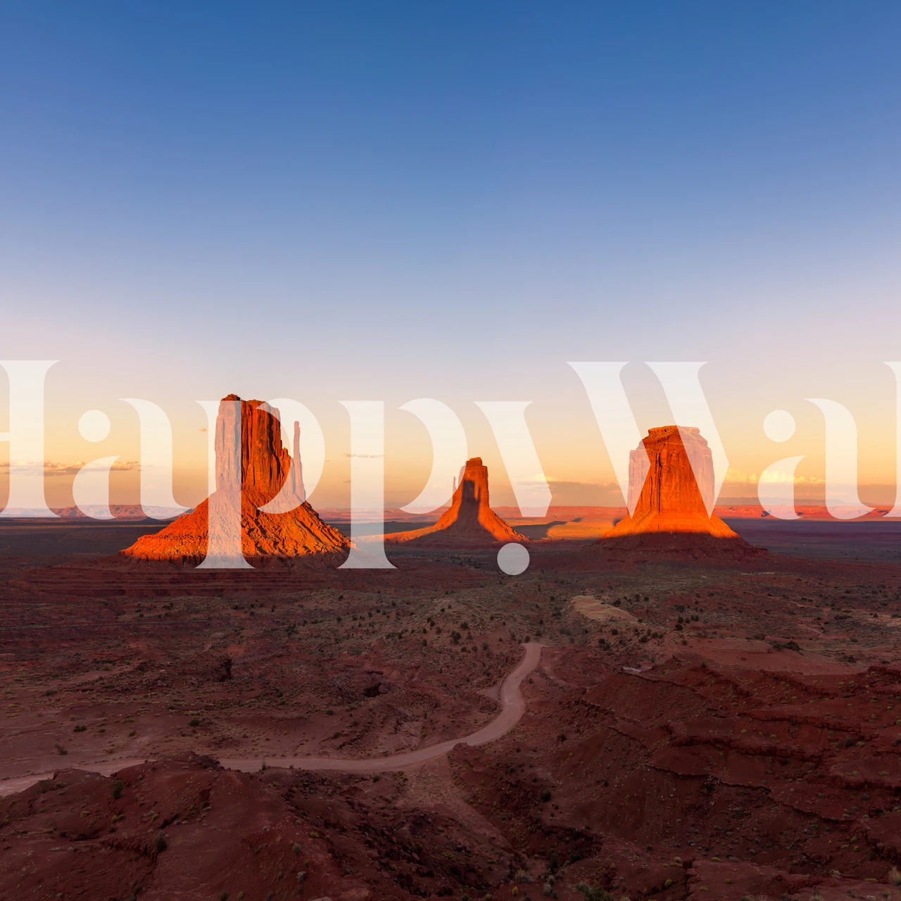 Desert sunset wall mural with landforms casts in amber