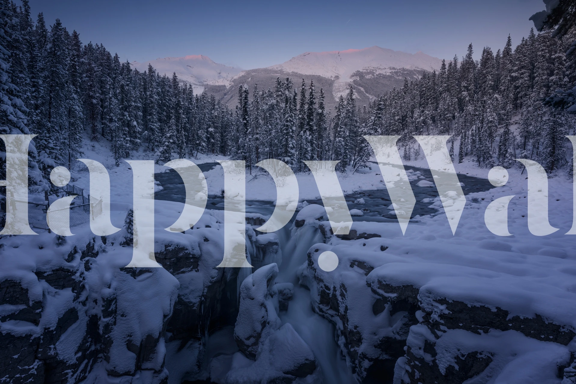 Snowy waterfall scene with evergreen trees and mountains wallpaper