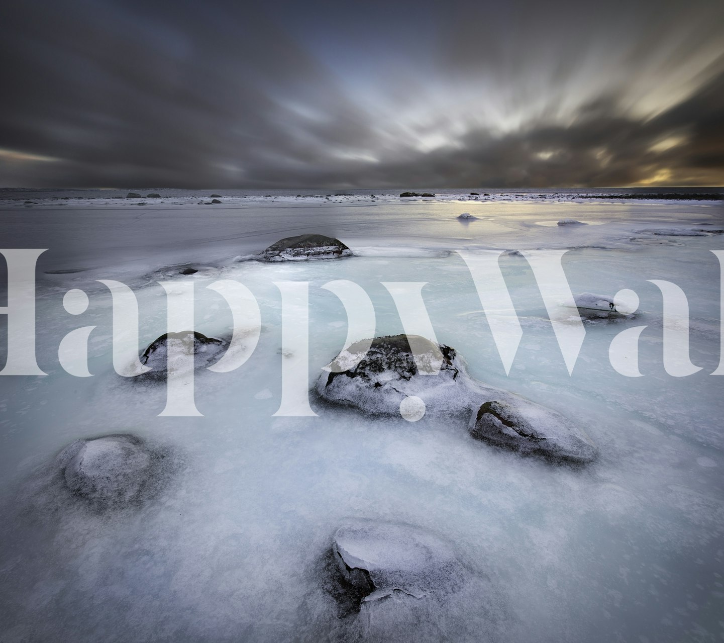 Frozen coastline with icy rocks and blue tones wallpaper