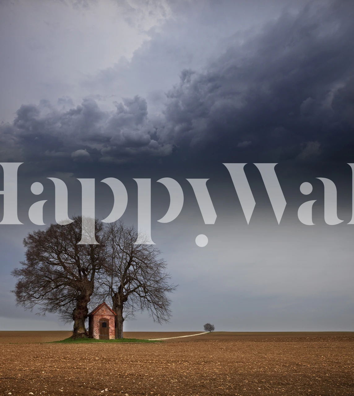 Lone tree and chapel under a stormy sky wall mural