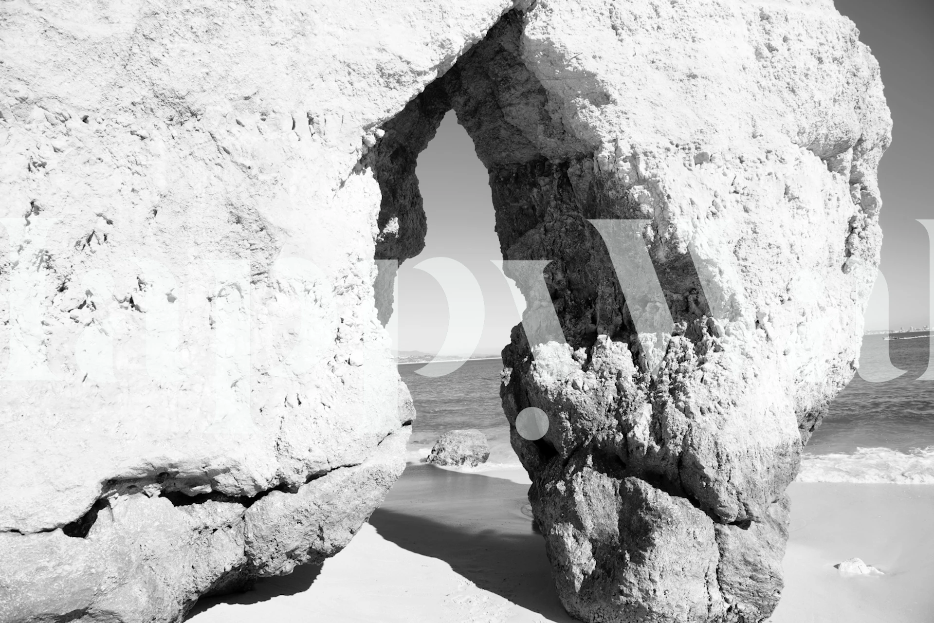 Monochromatyczna fototapeta przedstawiająca naturalny łuk na plaży Camilo w Portugalii