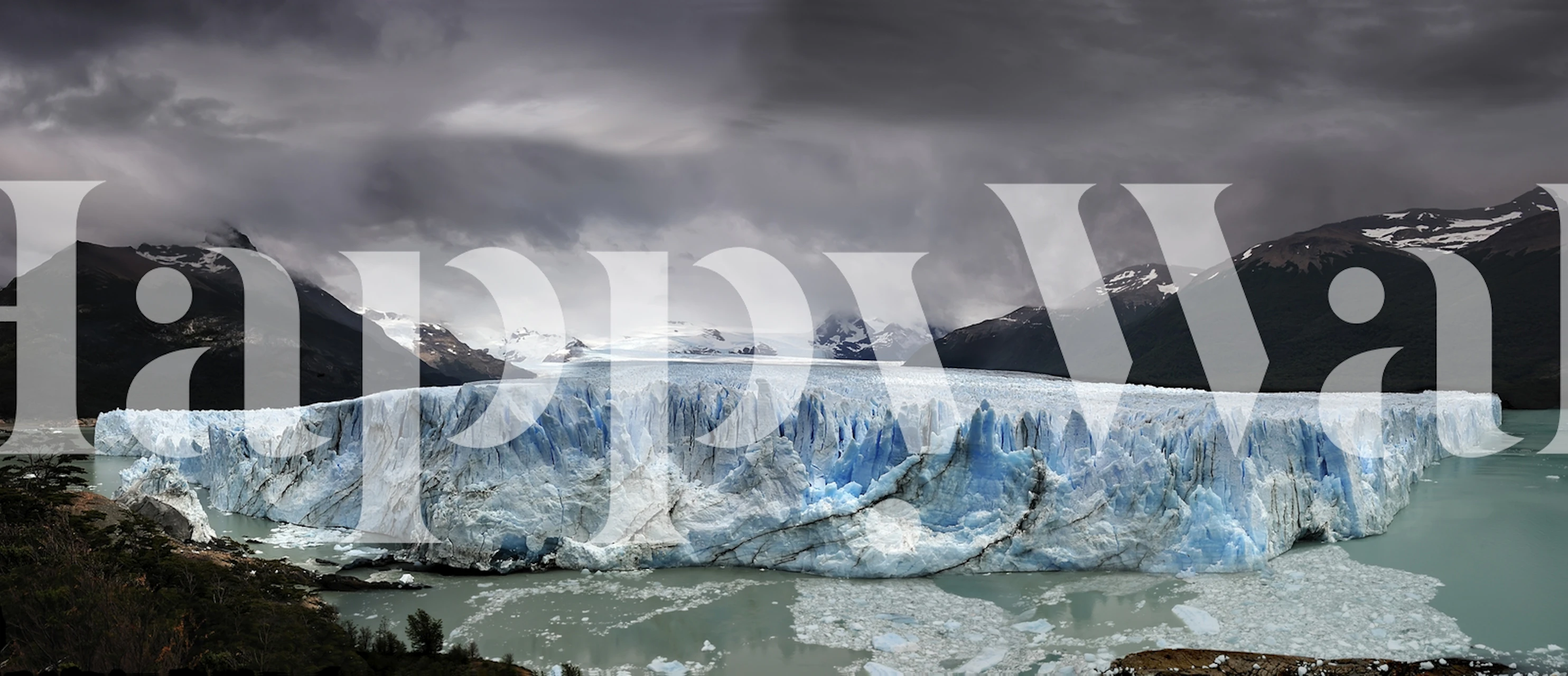 Glacier landscape with blue ice and dark mountains wallpaper