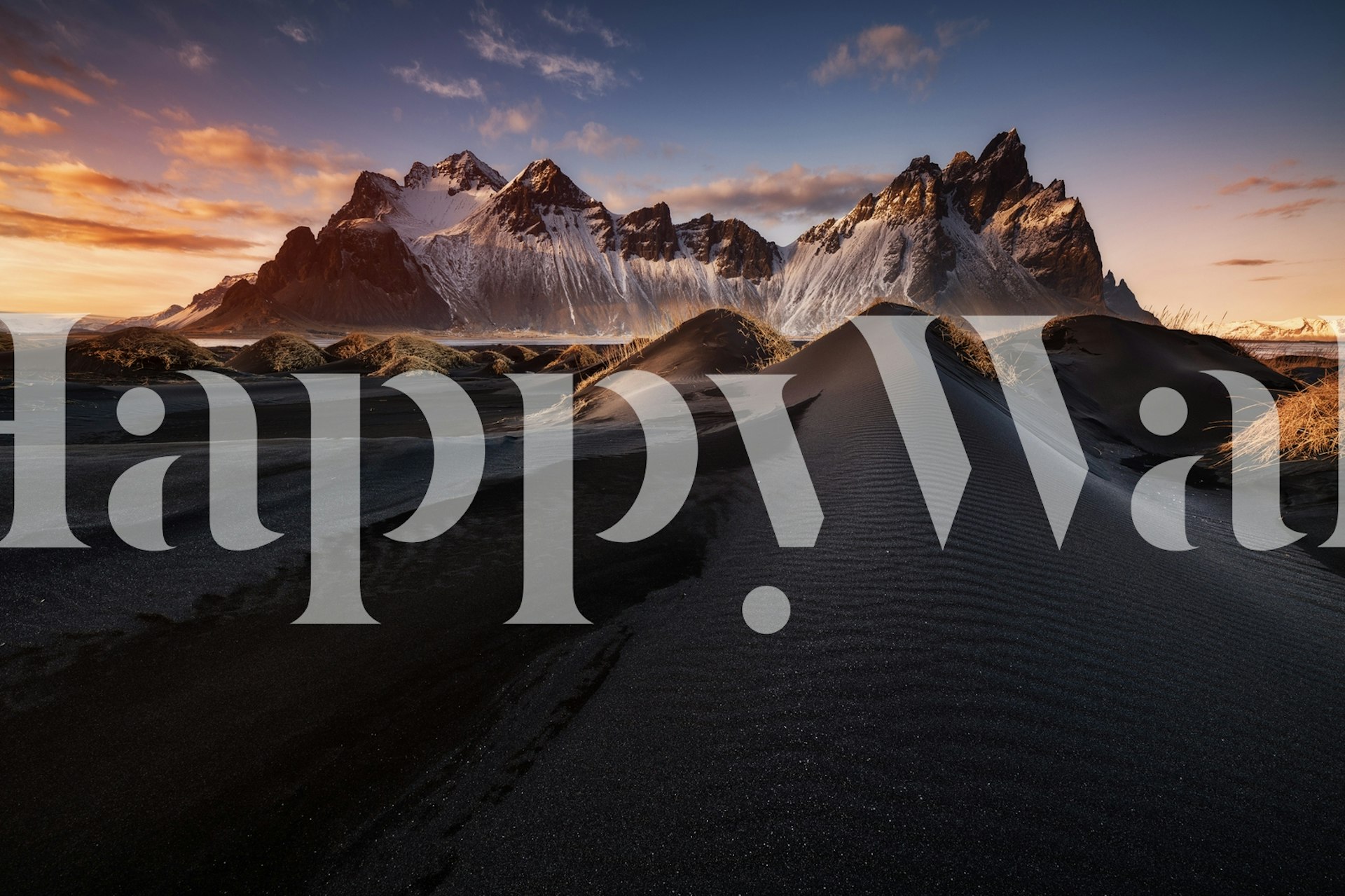 Black sand dunes with majestic mountains at sunset wallpaper