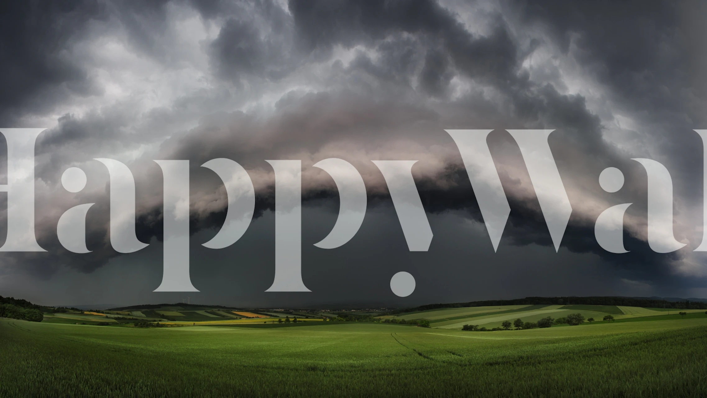 stormy sky with dark gray clouds over green fields wallpaper