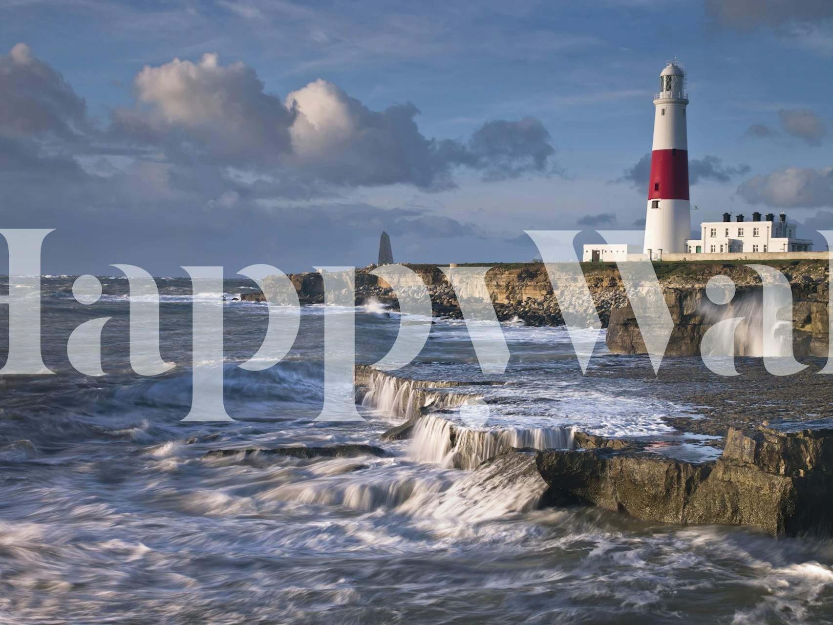 Lighthouse on cliffs and ocean waves with blue sky wallpaper