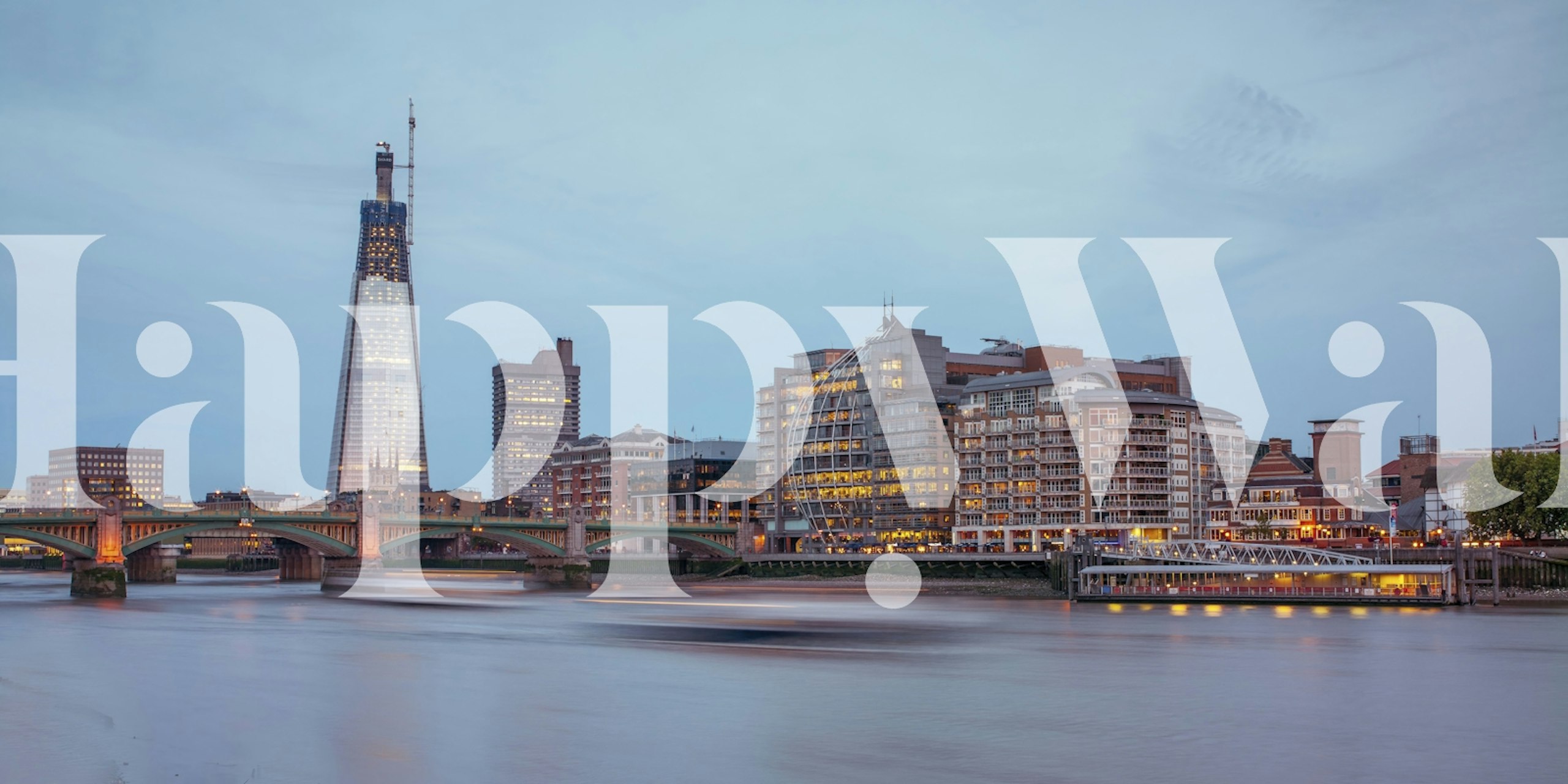 Twilight cityscape of London with illuminated buildings and Thames River
