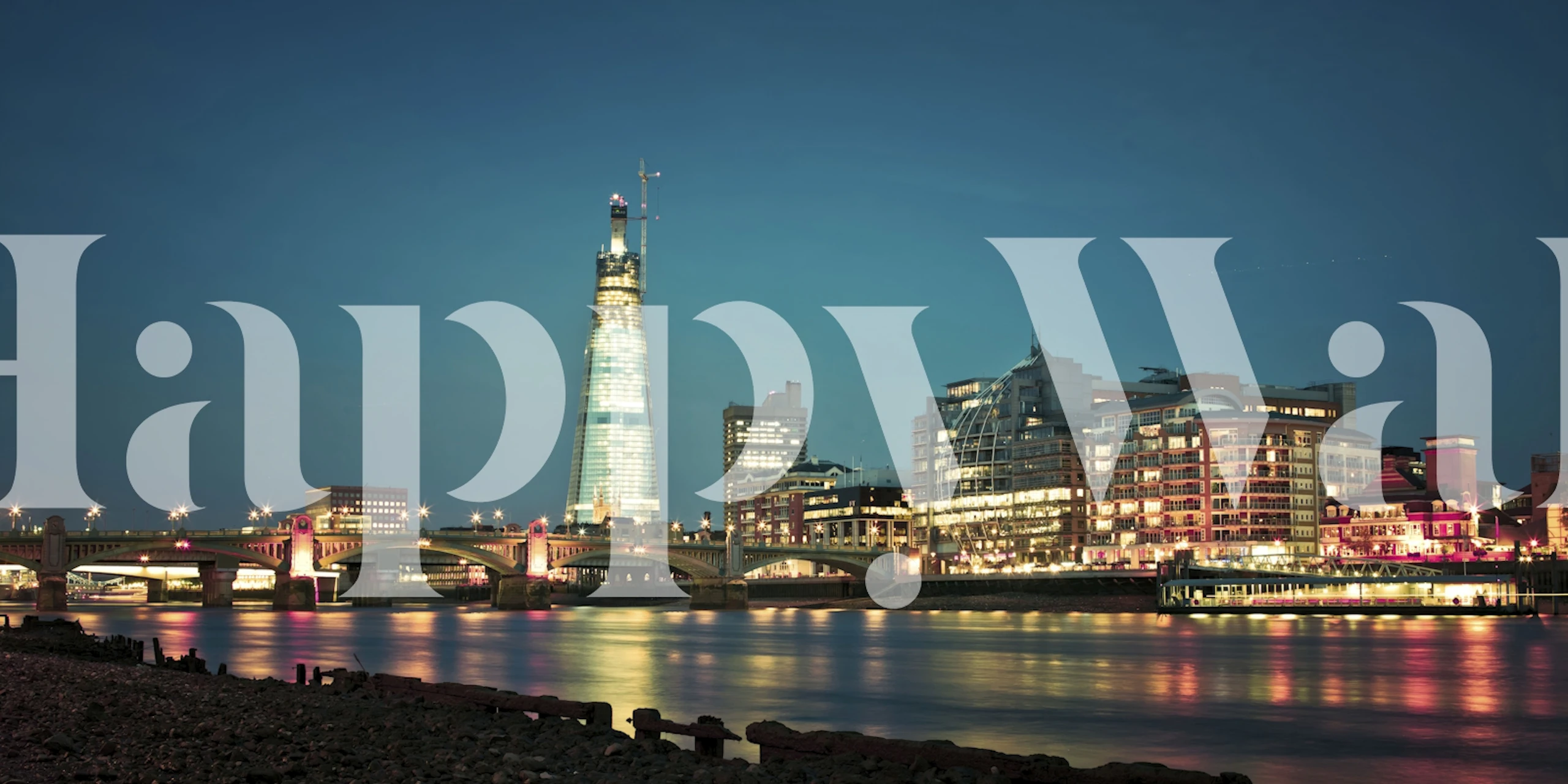 London skyline at night with lights reflecting on water wallpaper