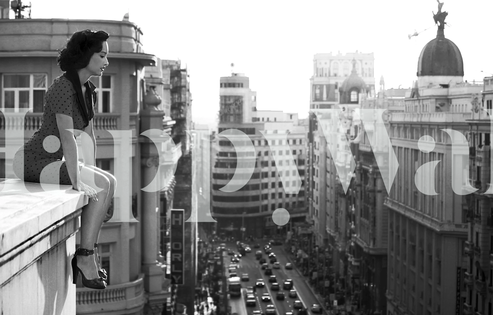 Black and white mural of a cityscape depicting Madrid's urban energy and historic buildings.