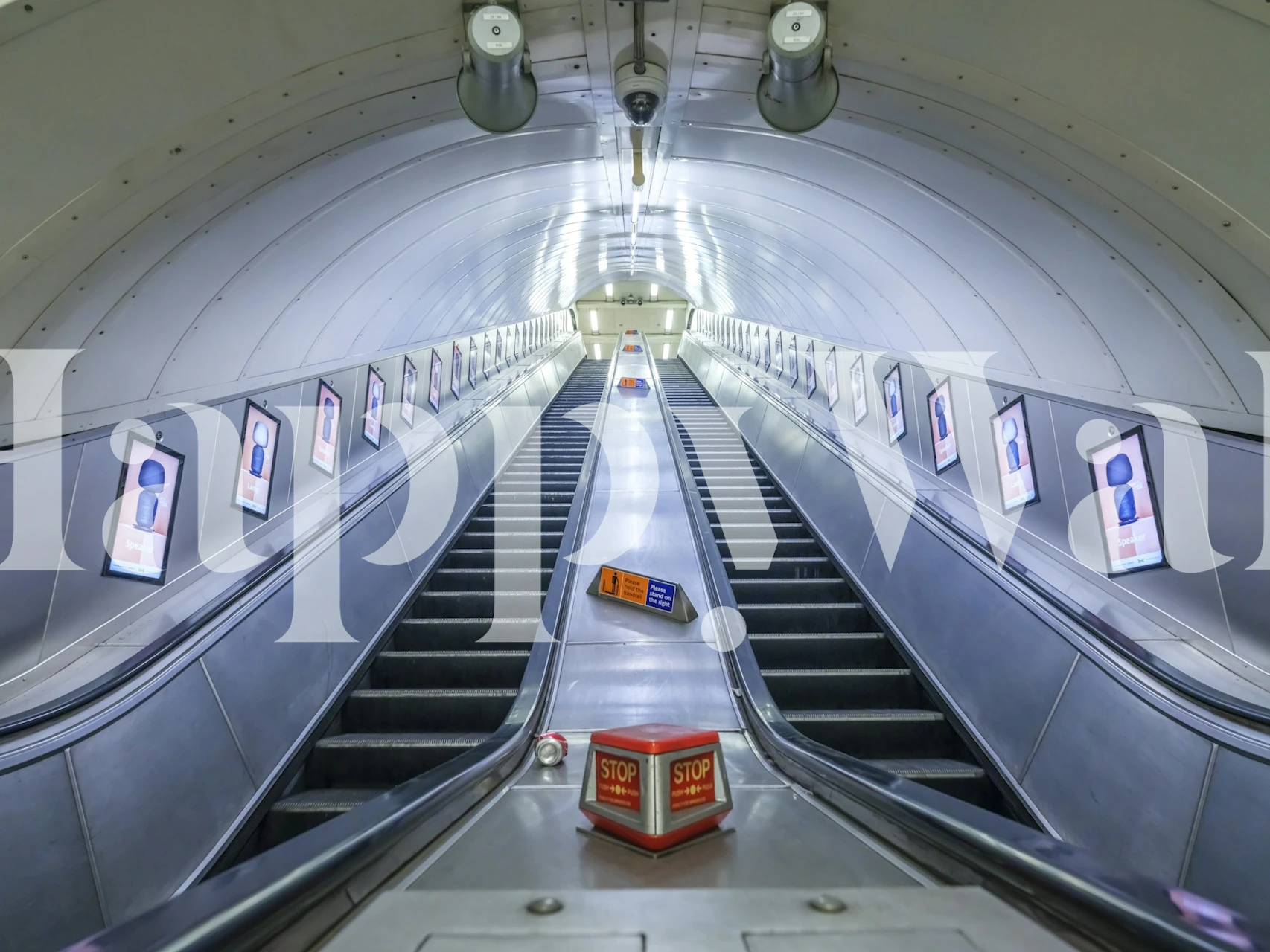 Escalator view with metal steps and white tunnel wallpaper
