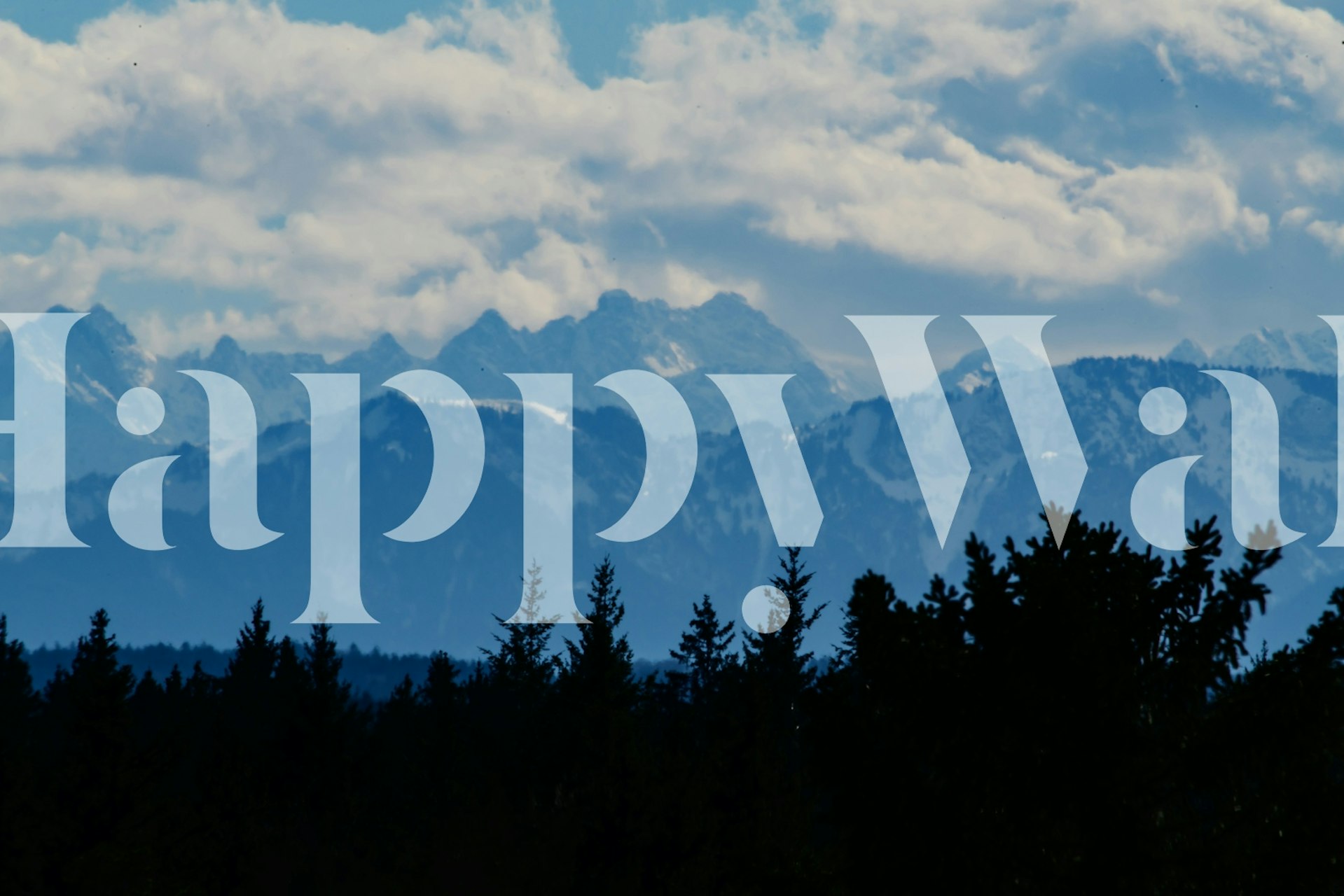 Dark trees silhouette against blue mountains and clouds wallpaper