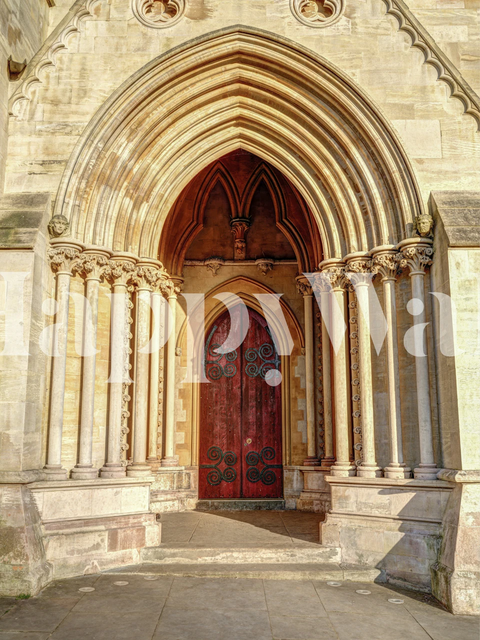 Intricate stone archway with wooden doors in earthy tones wallpaper