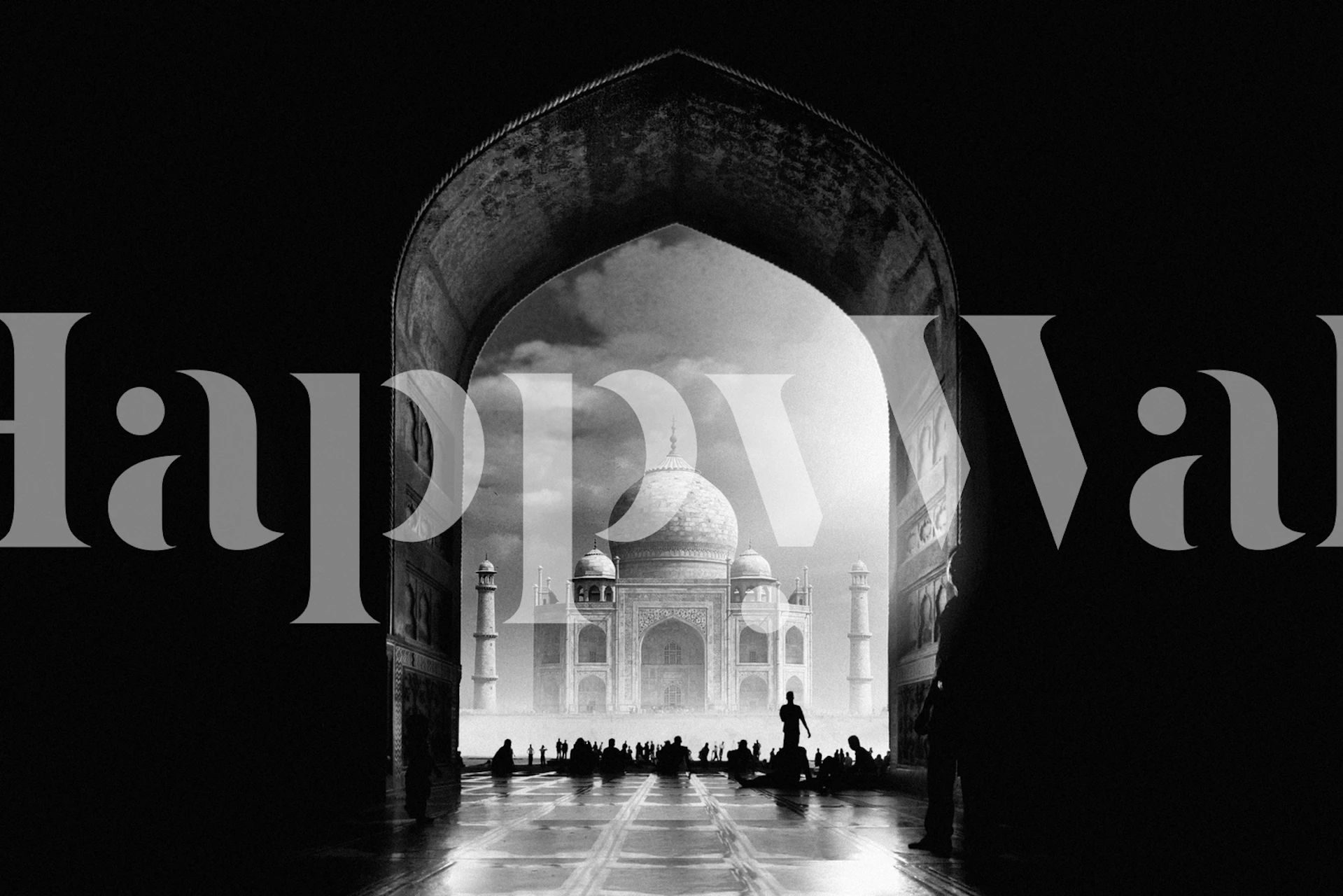 Taj Mahal silhouette framed by arch in black and white wallpaper