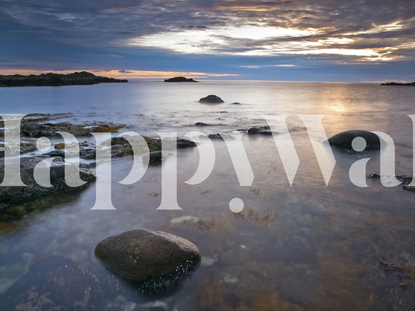 Ocean landscape with rocks and soft sunset colors wallpaper