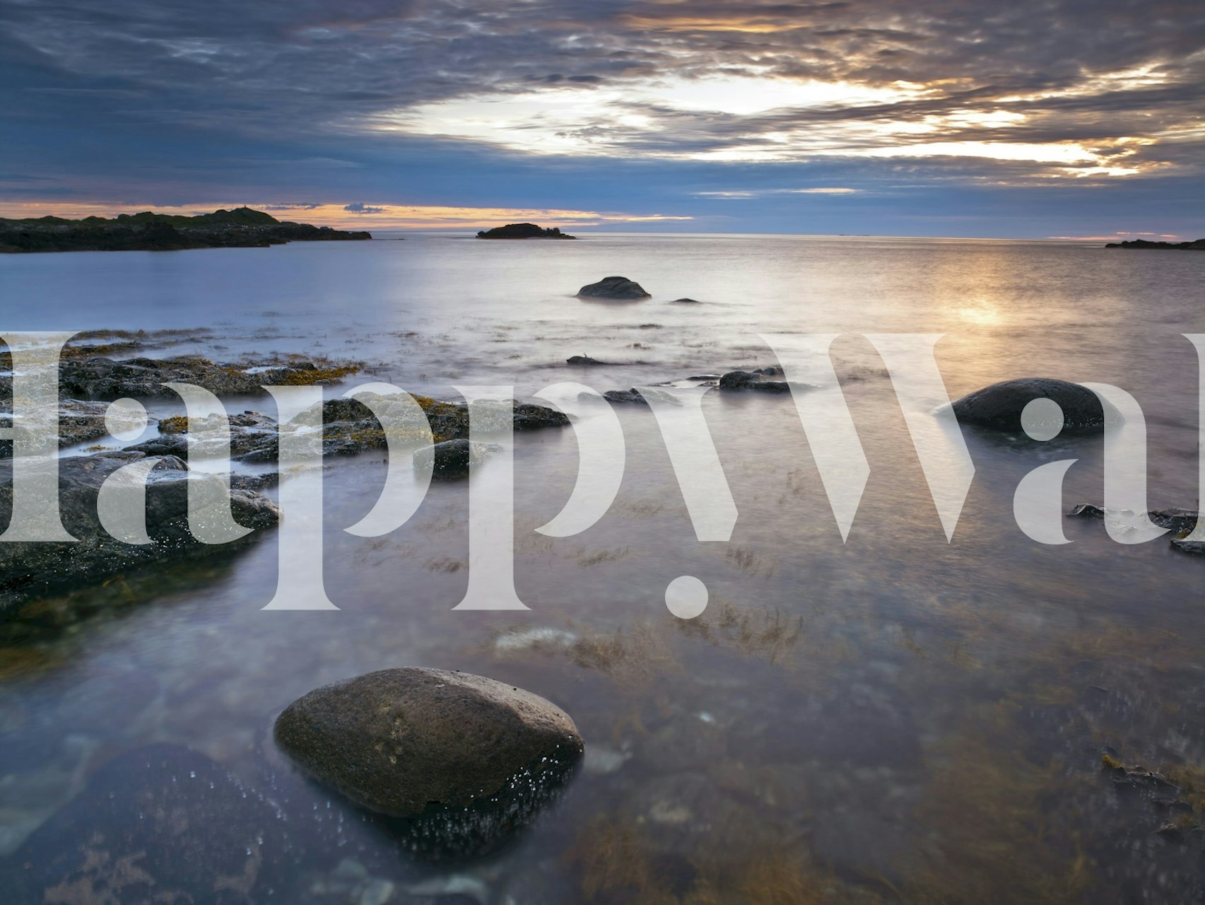 Ocean landscape with rocks and soft sunset colors wallpaper