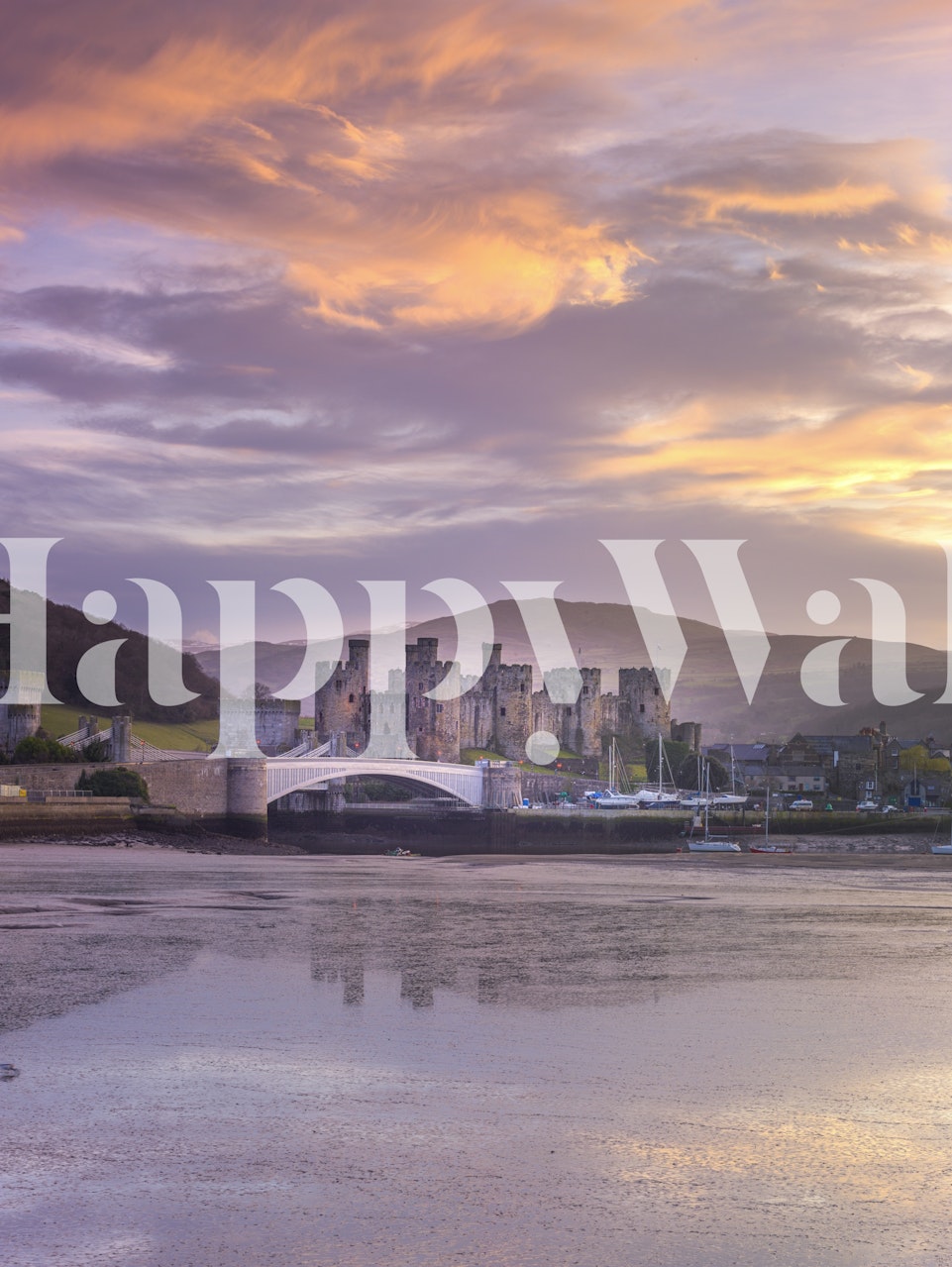Scenic view of Conwy Castle with sunset hues wallpaper