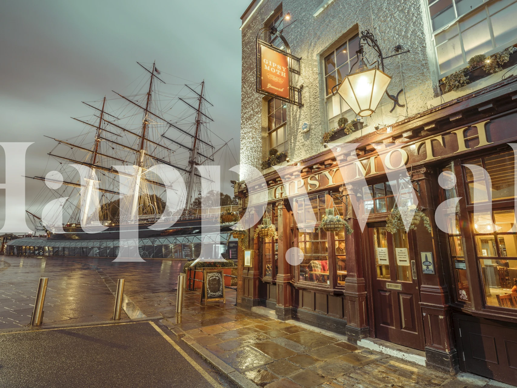 Thames riverside scene with historical pub and tall ship wall mural